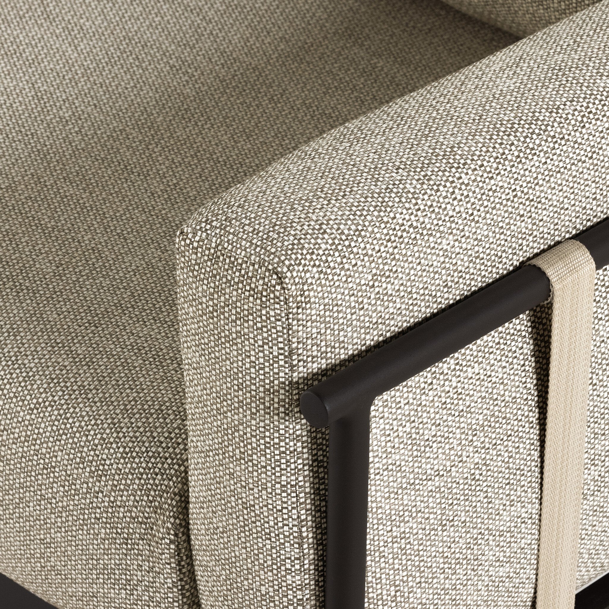 Close-up of a textured gray outdoor sofa with a black metal frame.