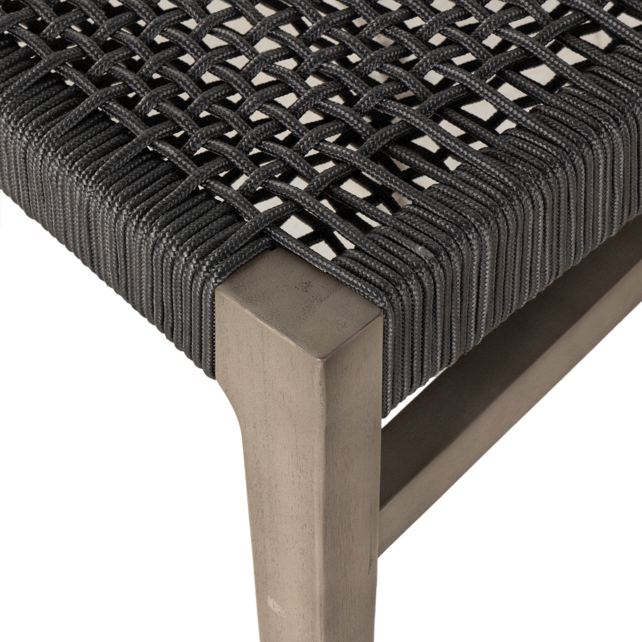 Close-up of a chair with woven seat and wooden frame on a white background