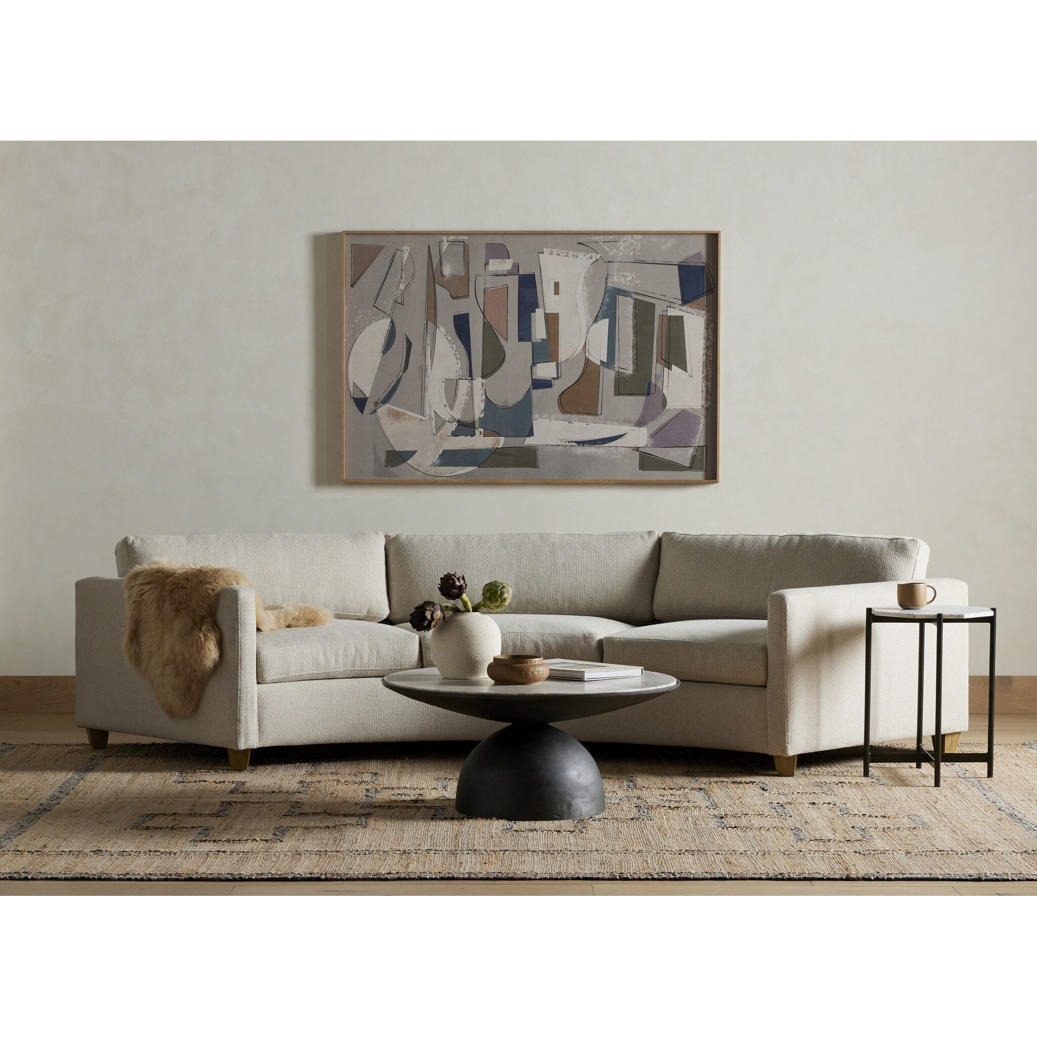 Modern living room with a beige sofa, coffee table, and abstract painting on the wall.