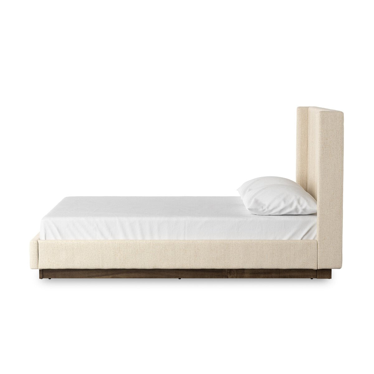 Beige bed with white mattress and pillow