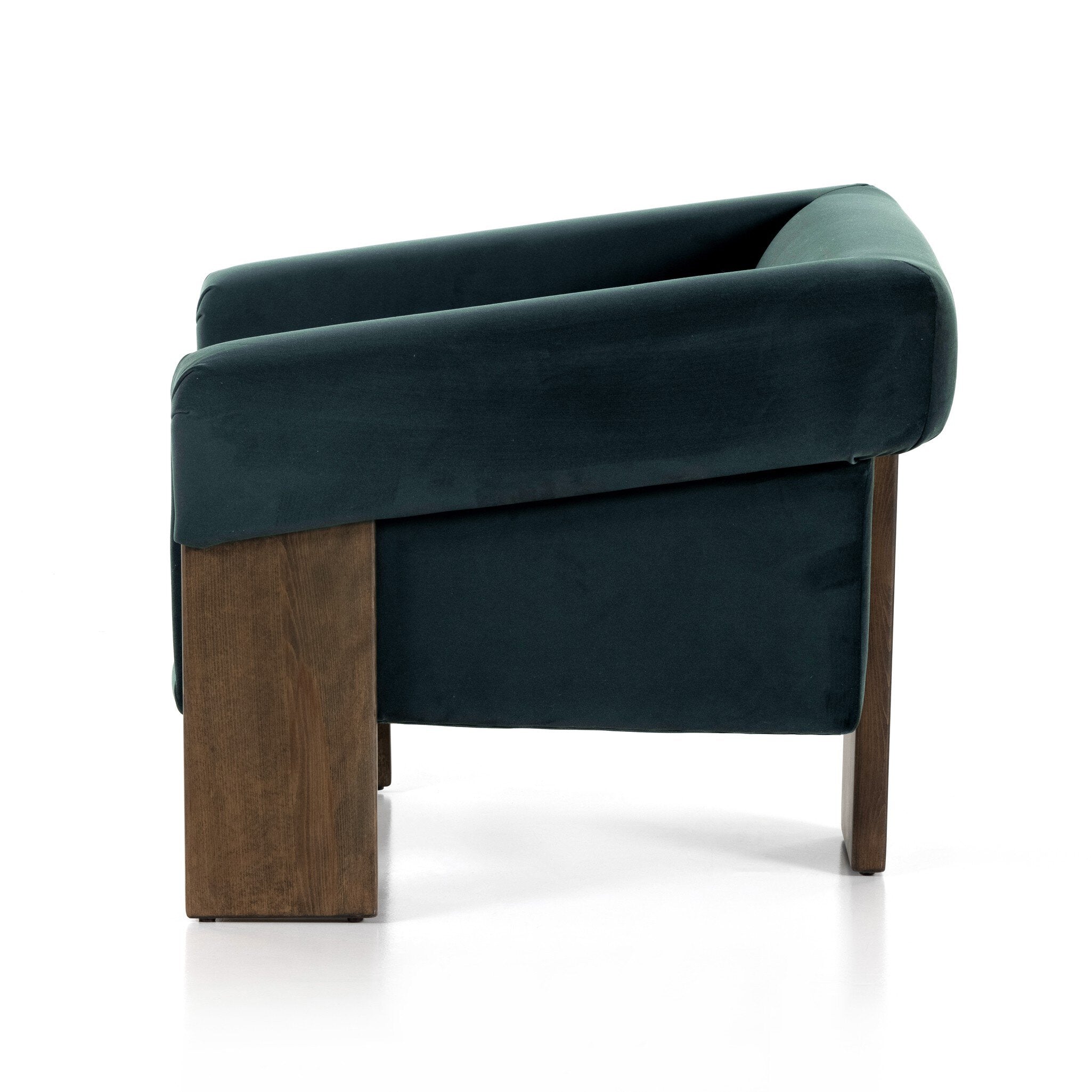 Green velvet armchair with wooden legs on a white background