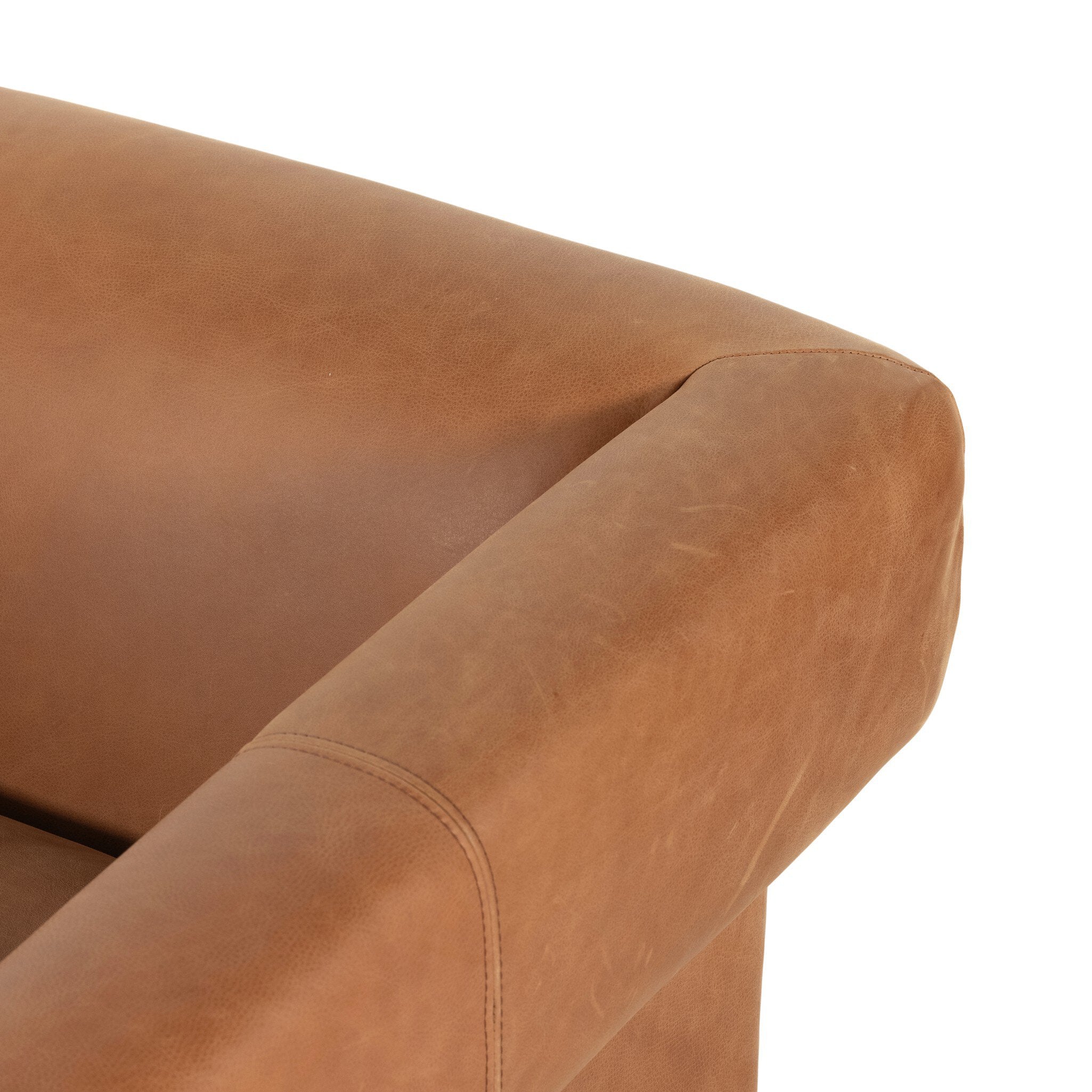 Close-up of a brown leather armchair corner on a white background