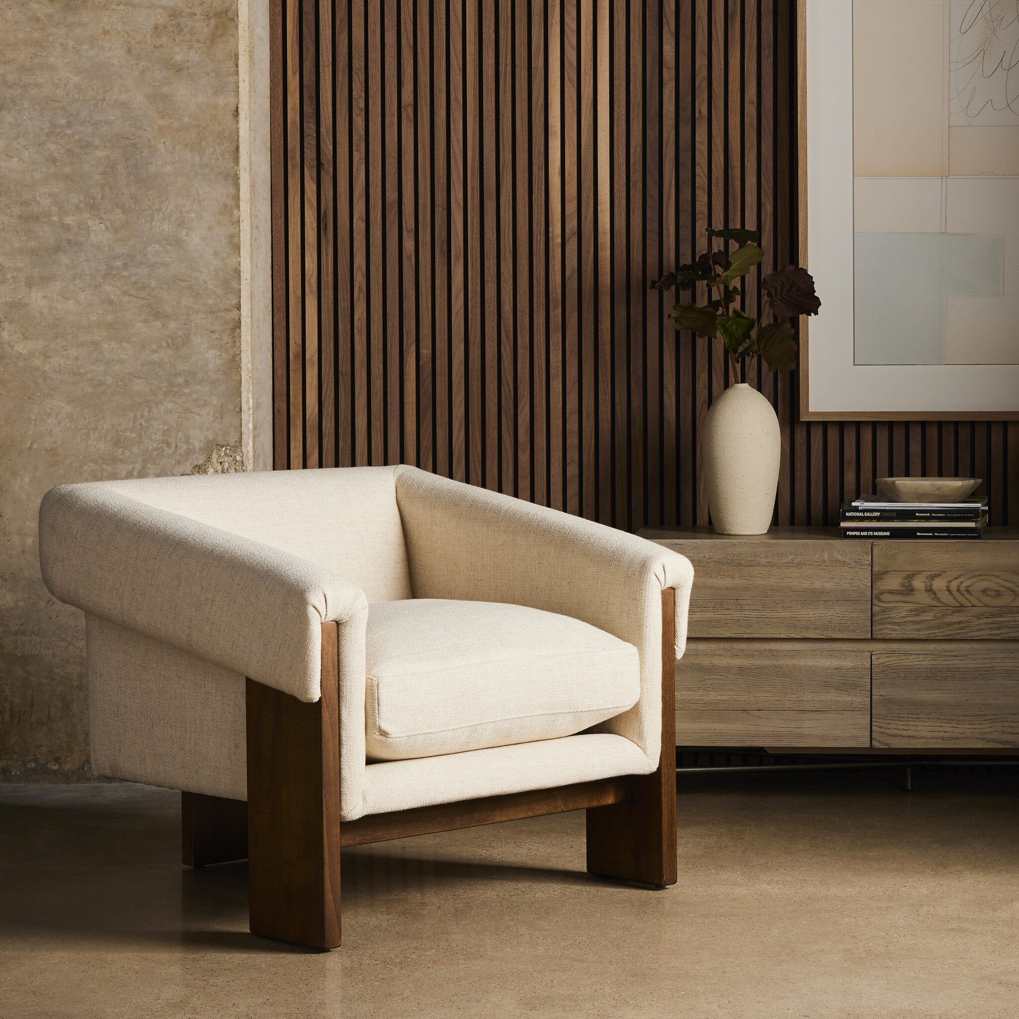 Beige armchair in a room with wooden furniture and decor