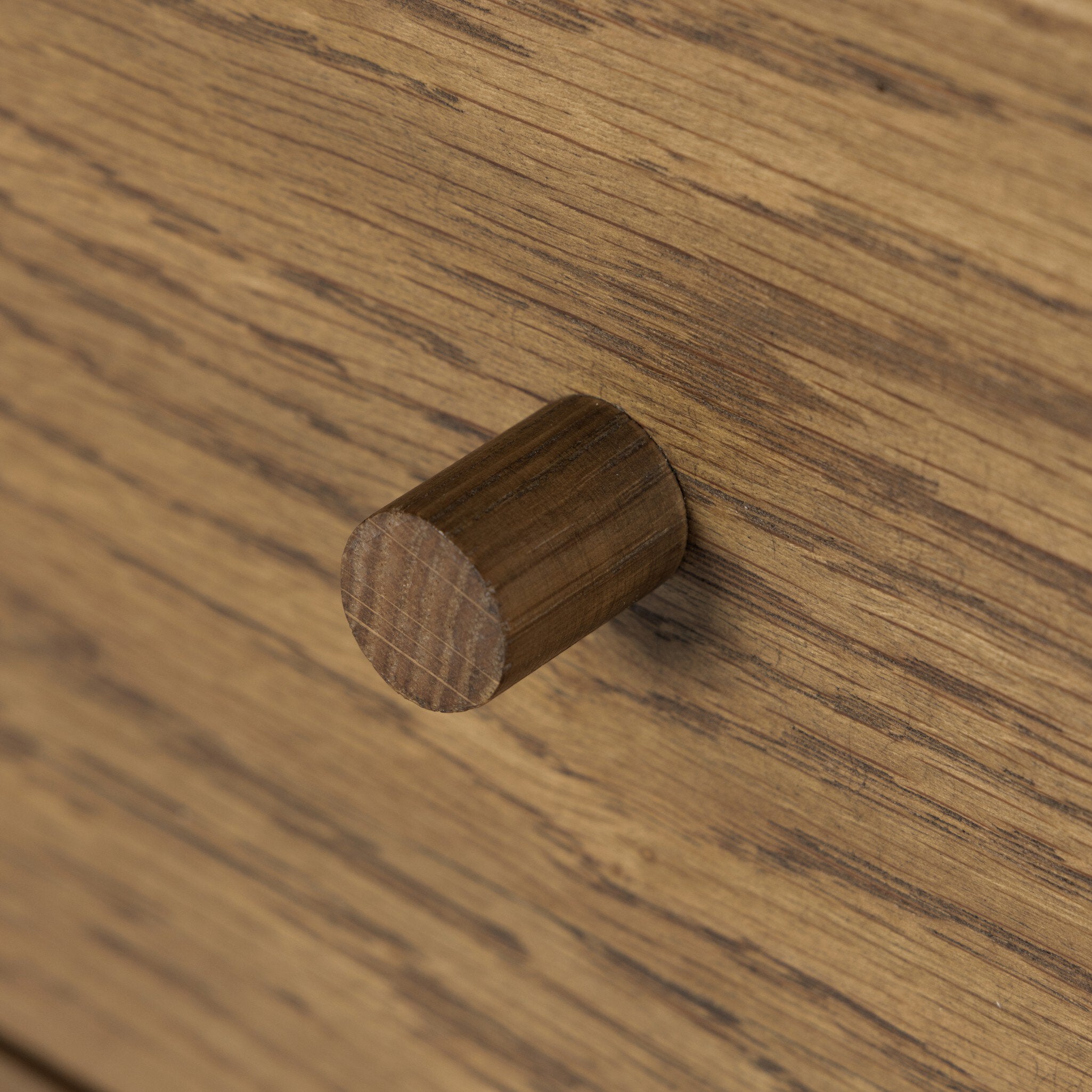 Wooden knob on a wooden dresser drawer