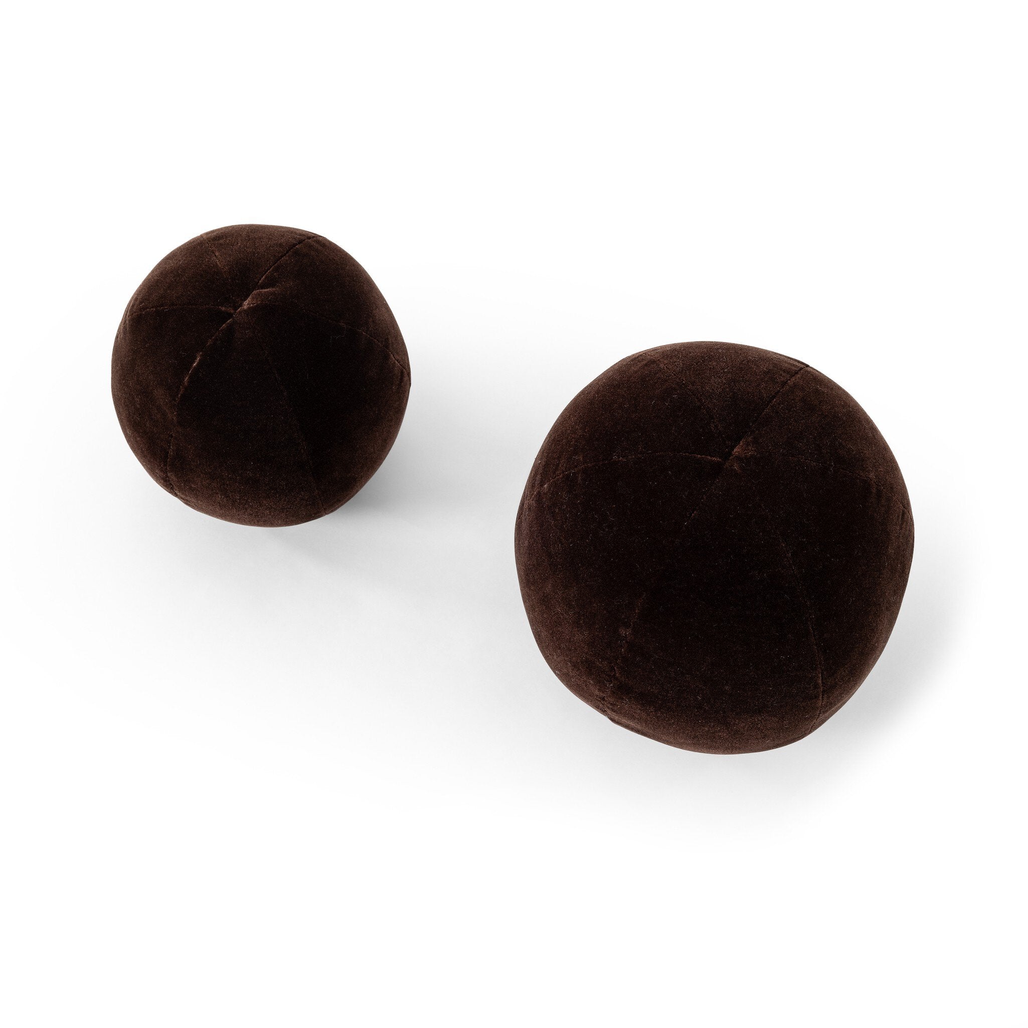 Two brown round velvet pillows on a white background