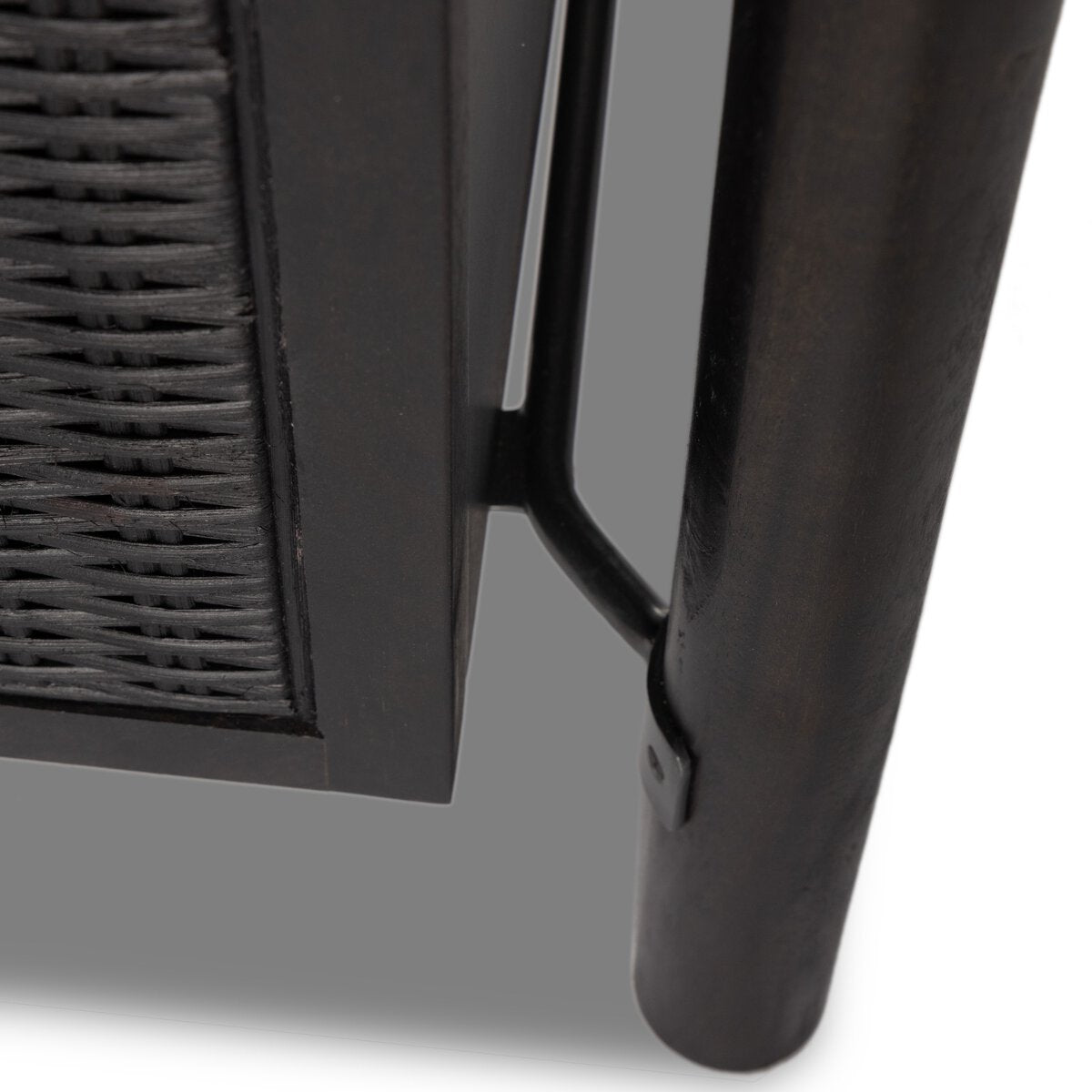 Close-up of a black woven chair armrest
