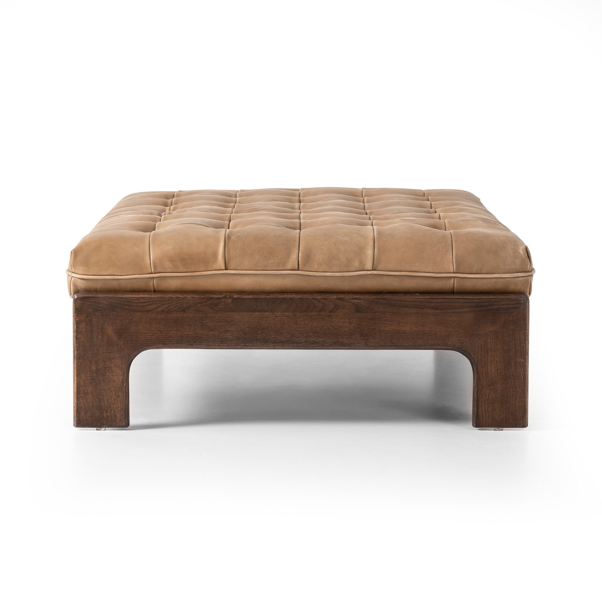 Brown ottoman with wooden legs on a white background