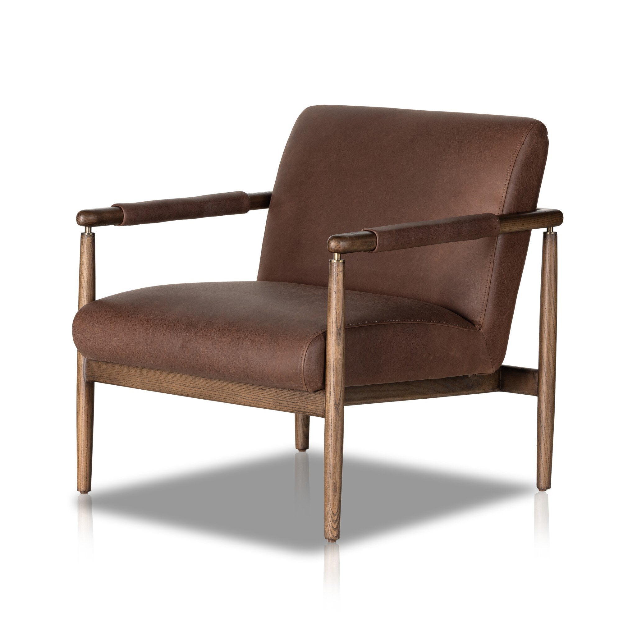A brown midcentury-style leather chair with brass metal detailing and a solid ash frame.