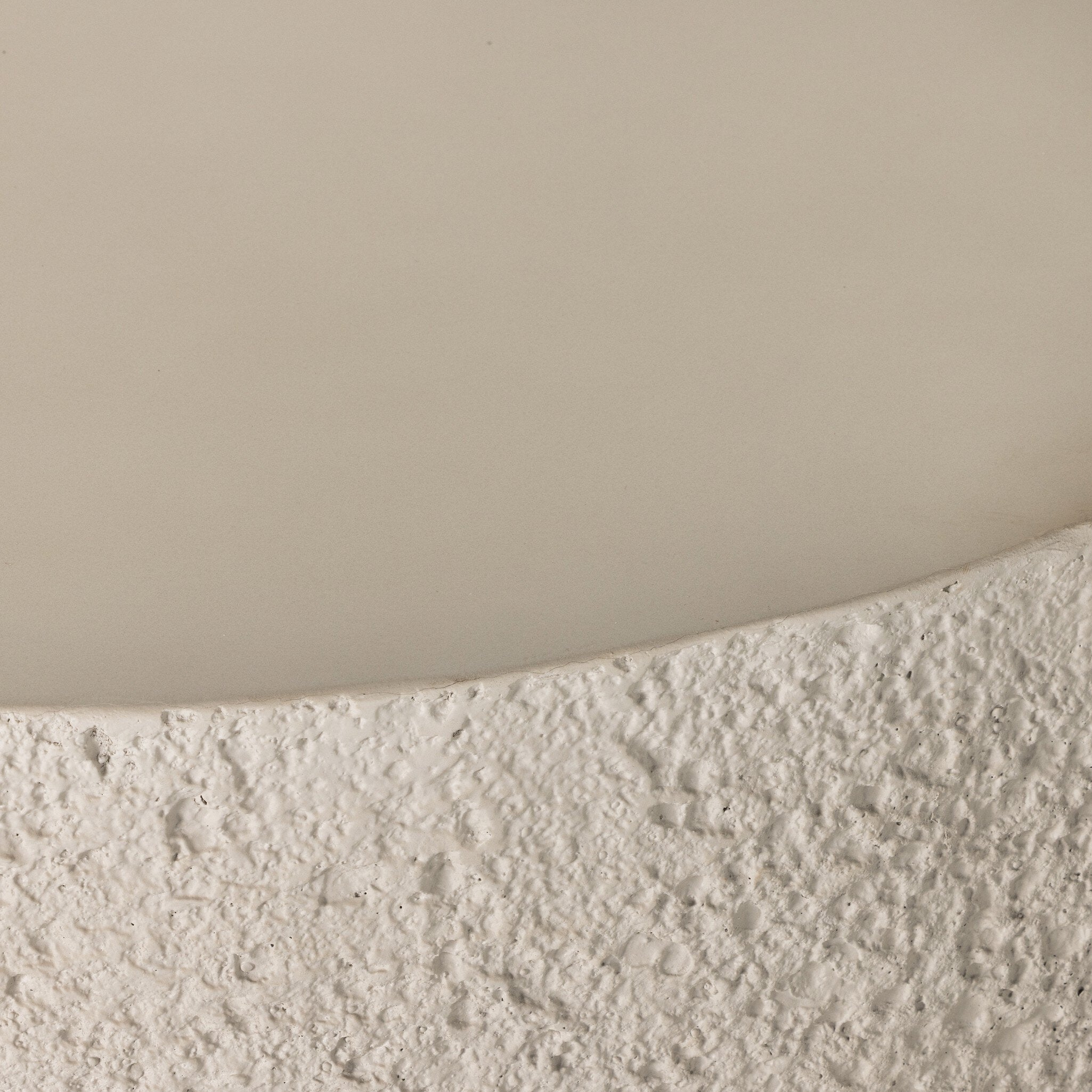 Close-up of textured coffee table surface with a neutral background
