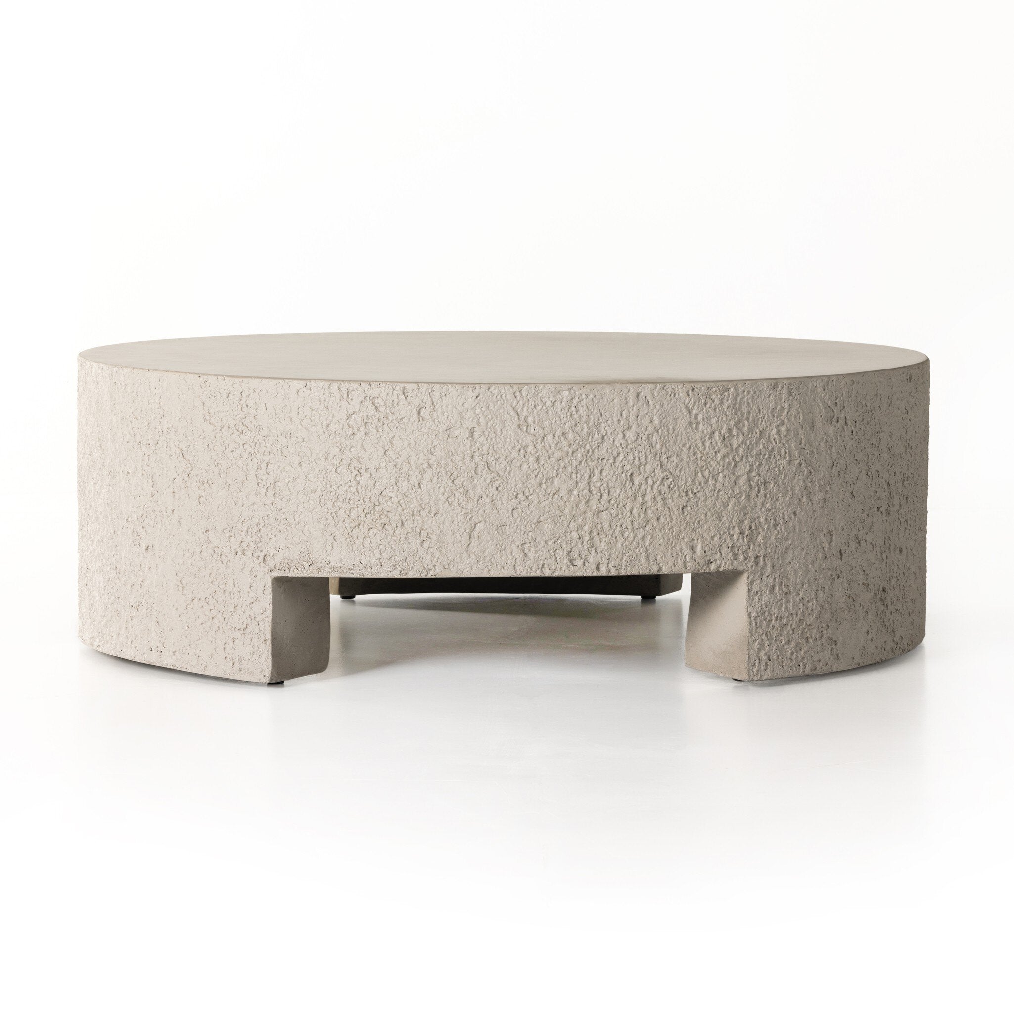 Round textured coffee table on a white background