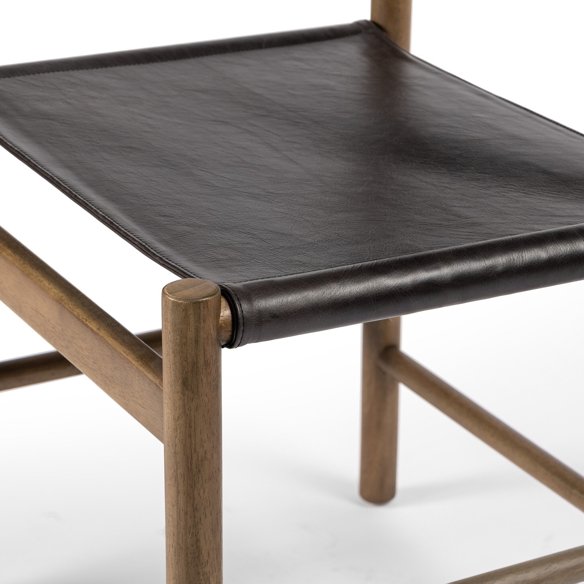 Chair with black leather seat and wooden frame on a white background