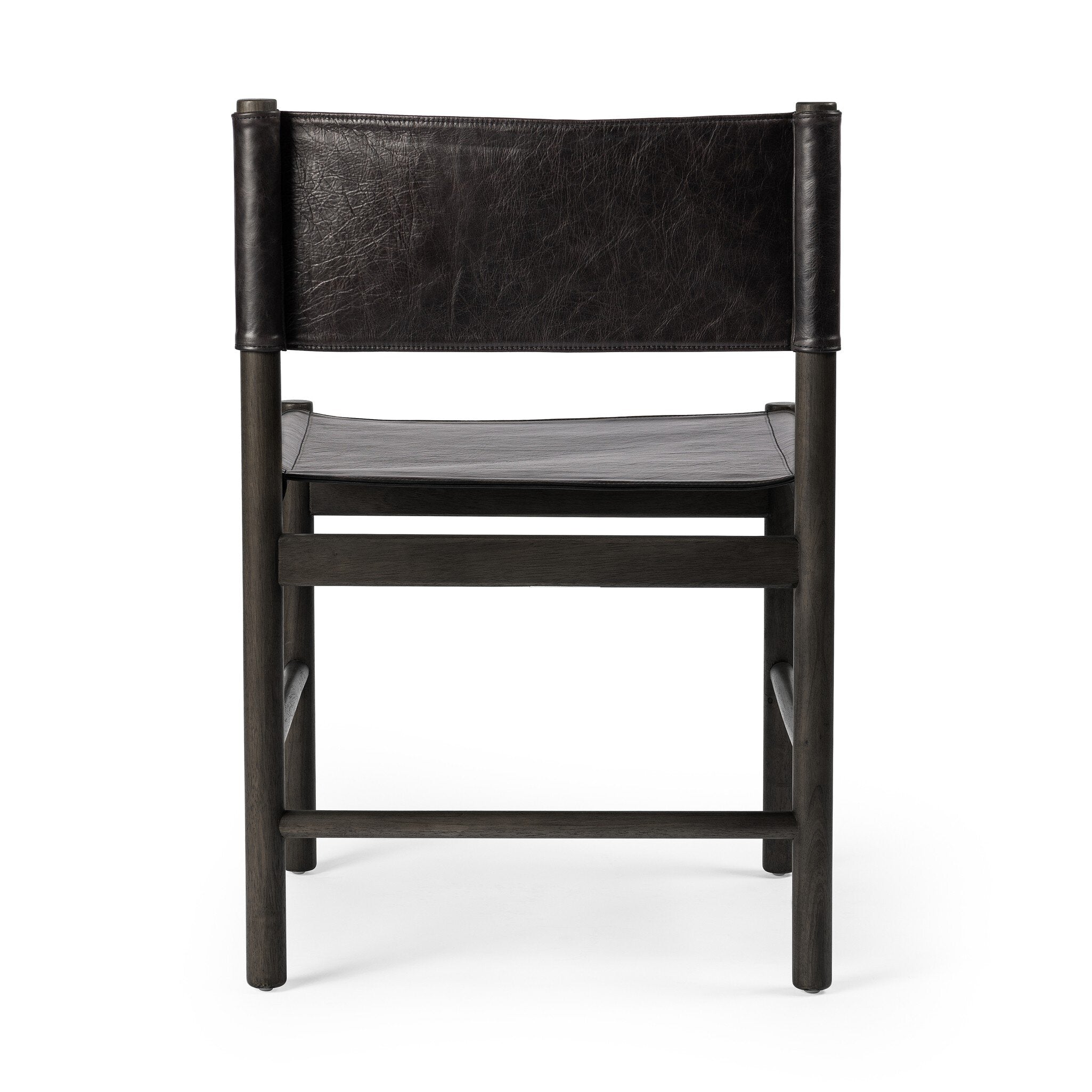 Back view of a black leather dining chair on a white background