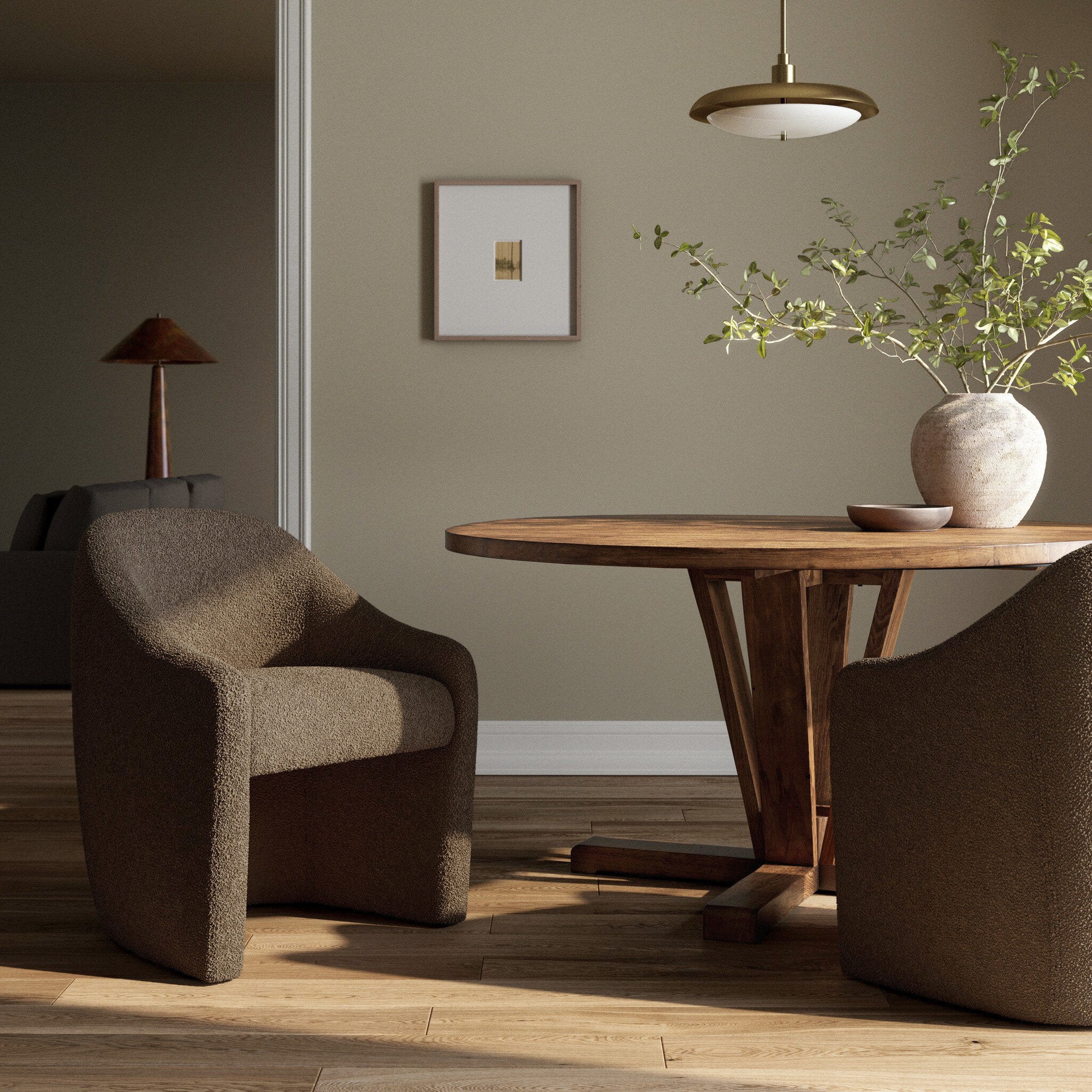 Modern living room with brown armchair, wooden table, and decorative elements.