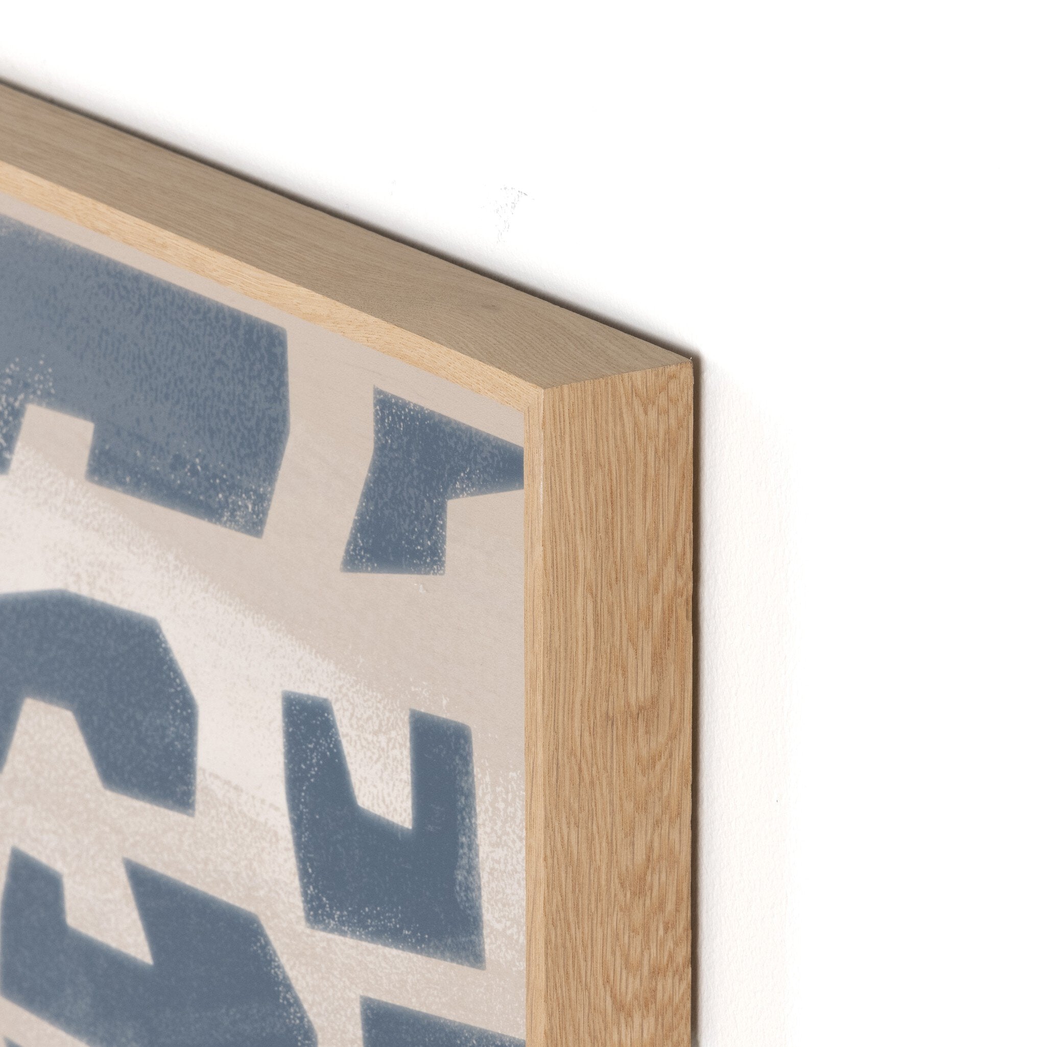 Close-up of a wooden frame with a decorative pattern on a white background