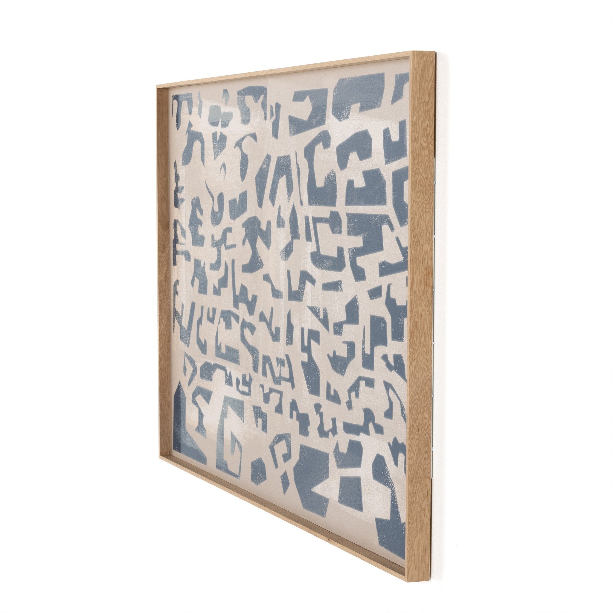 Framed abstract artwork with blue geometric patterns on a white background