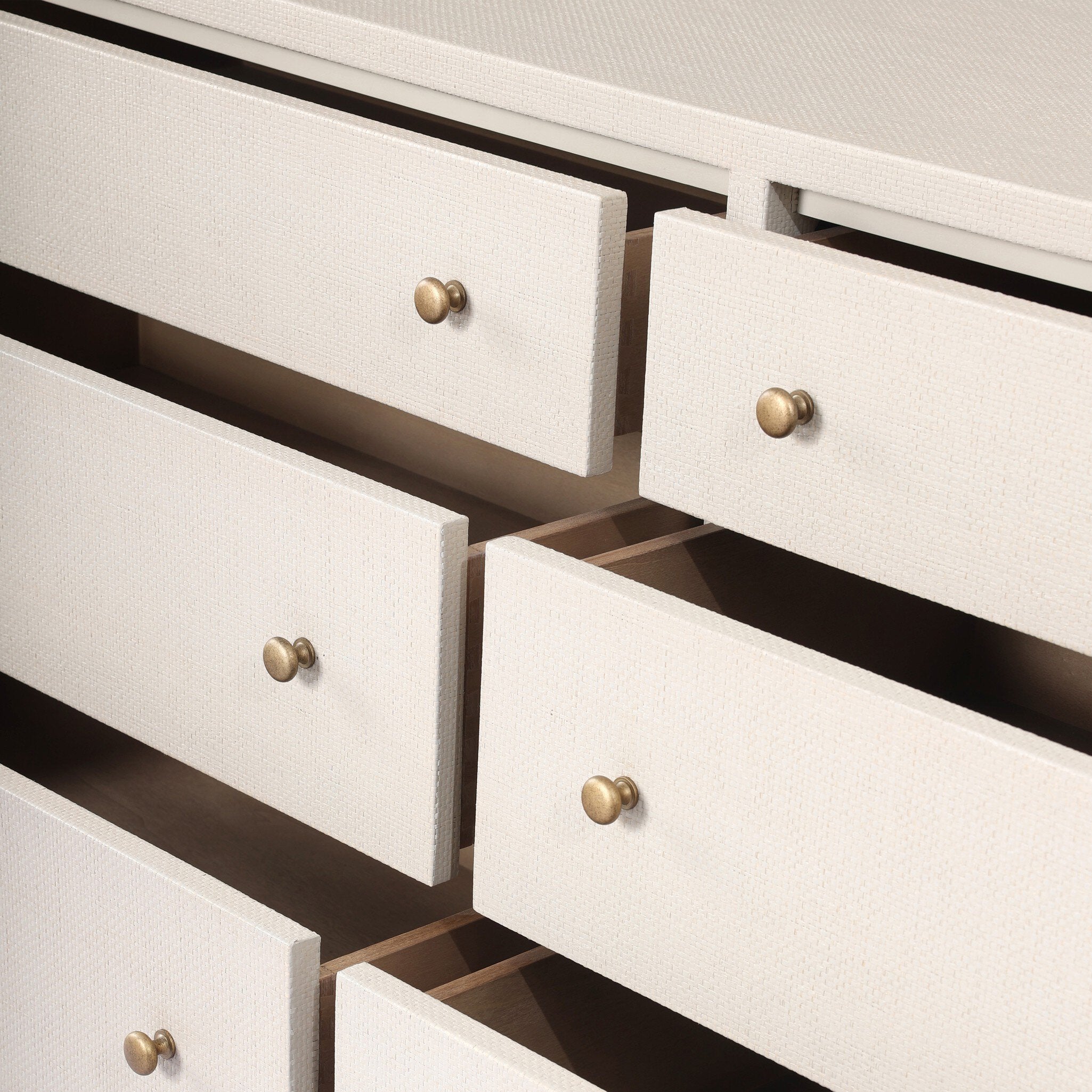 Close-up of white drawers with gold knobs