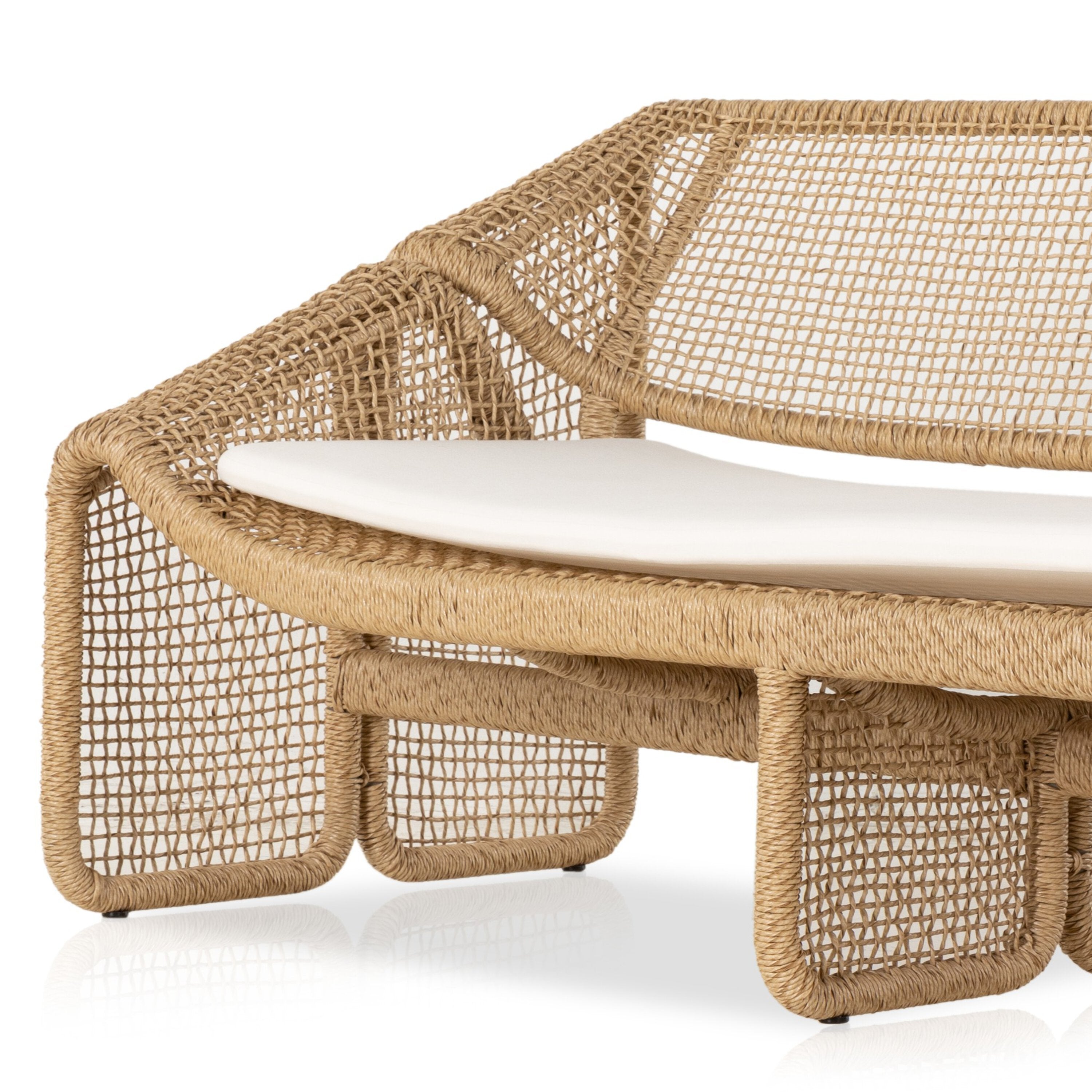 An outdoor sofa with a beige all-weather wicker frame and a white cushion.
