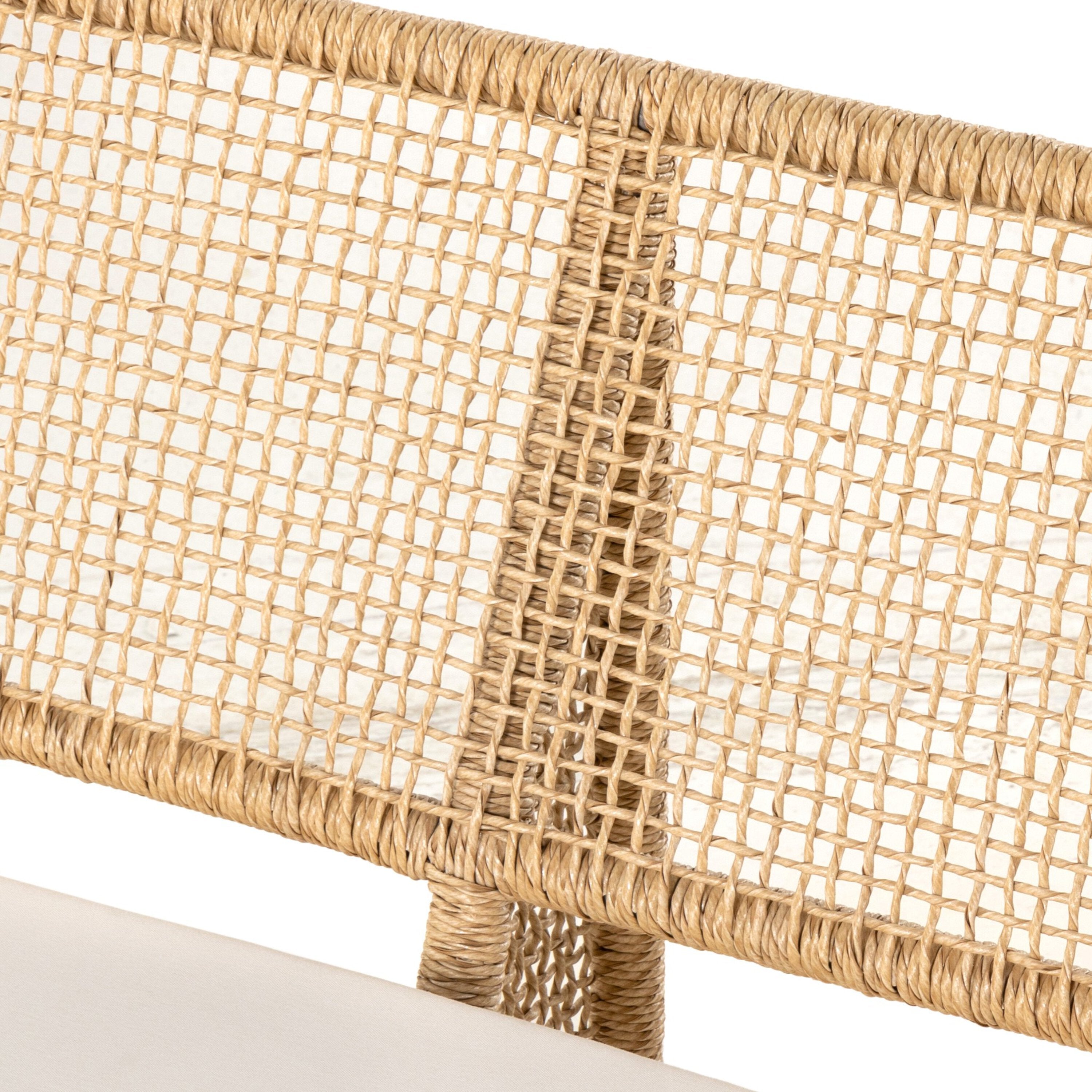 An outdoor sofa with a beige all-weather wicker frame and a white cushion.