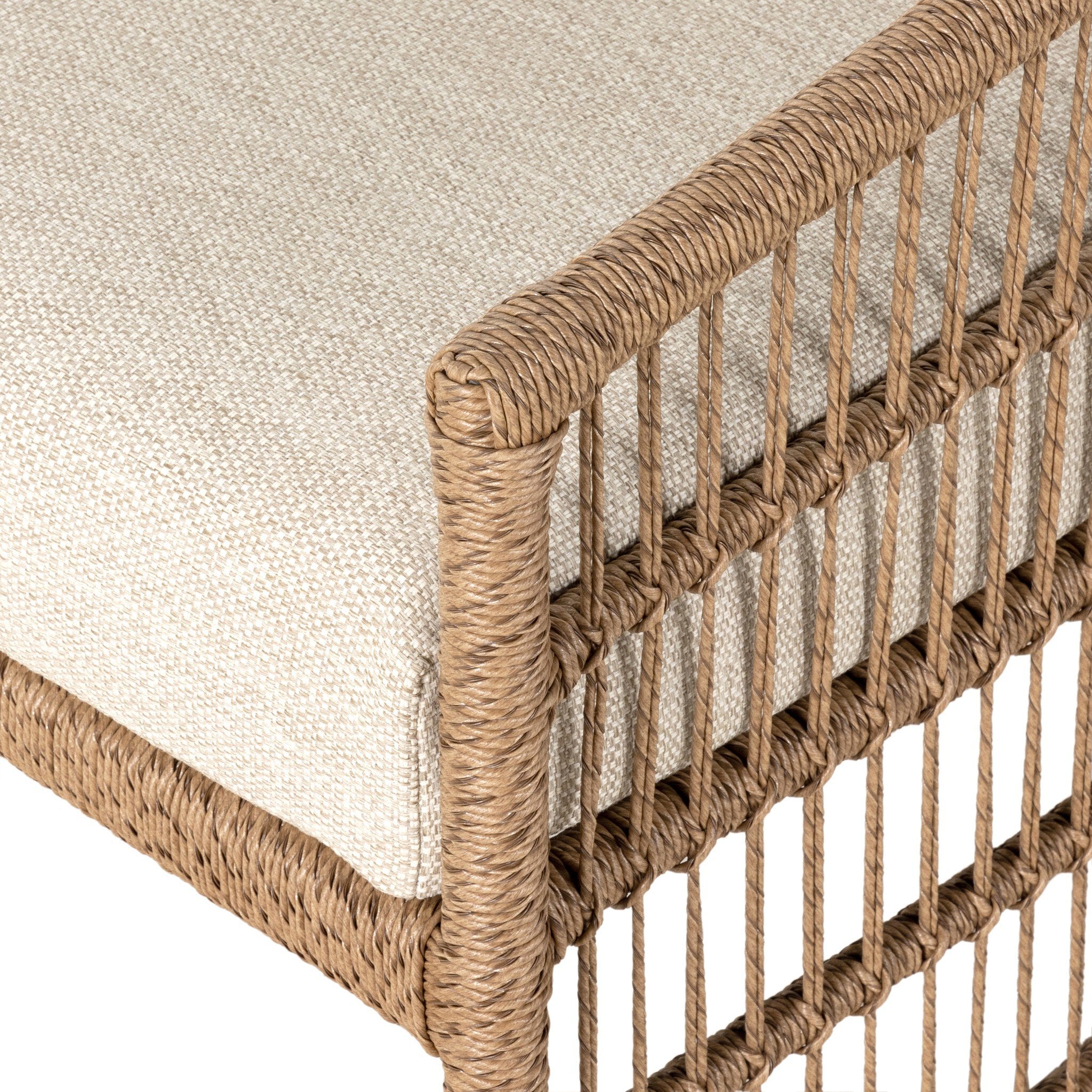 Close-up of a chair with woven backrest and beige cushion
