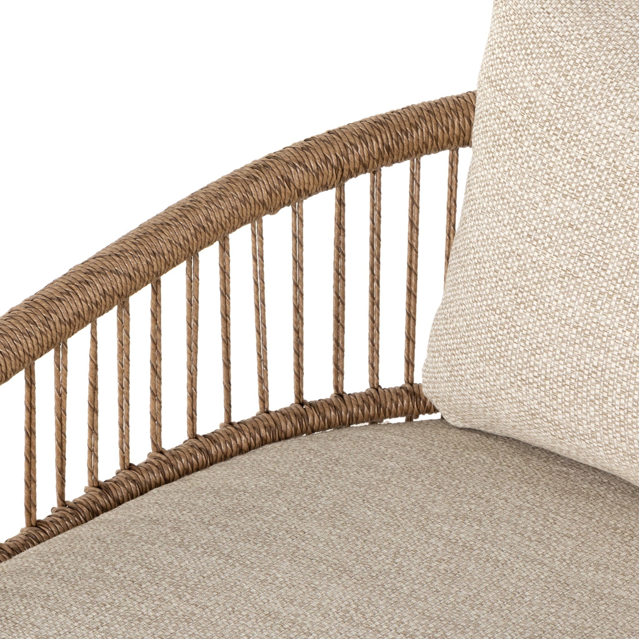 Close-up of a wicker chair with beige cushion on a white background