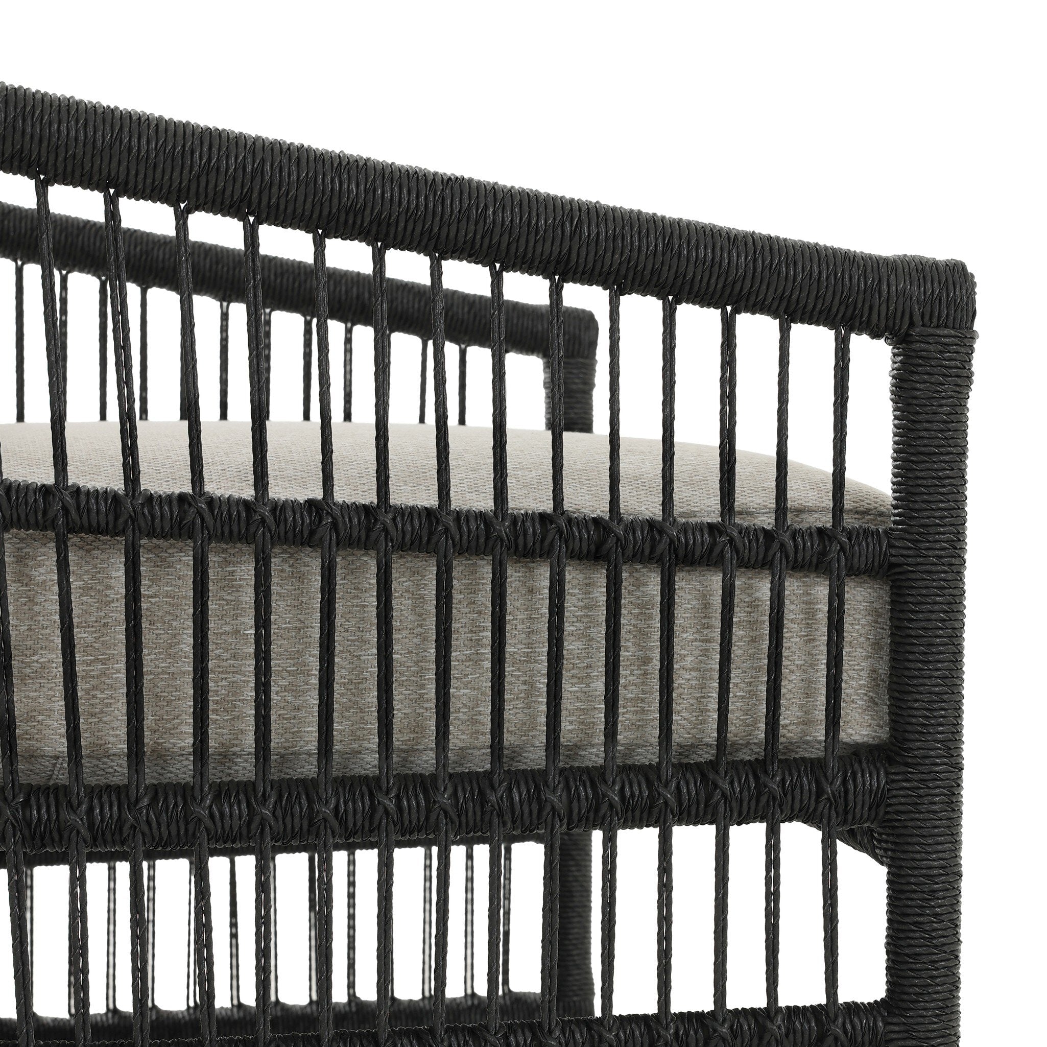 Close-up of a black woven chair with a white cushion on a white background