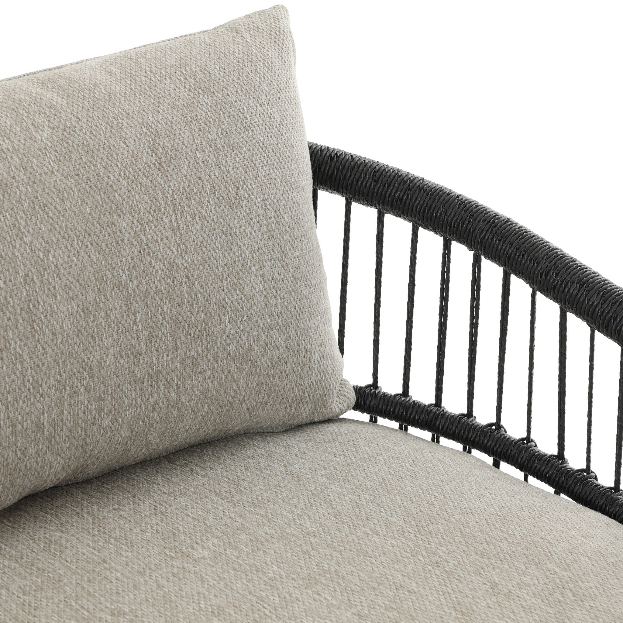 Gray cushion on a black wicker chair with a white background