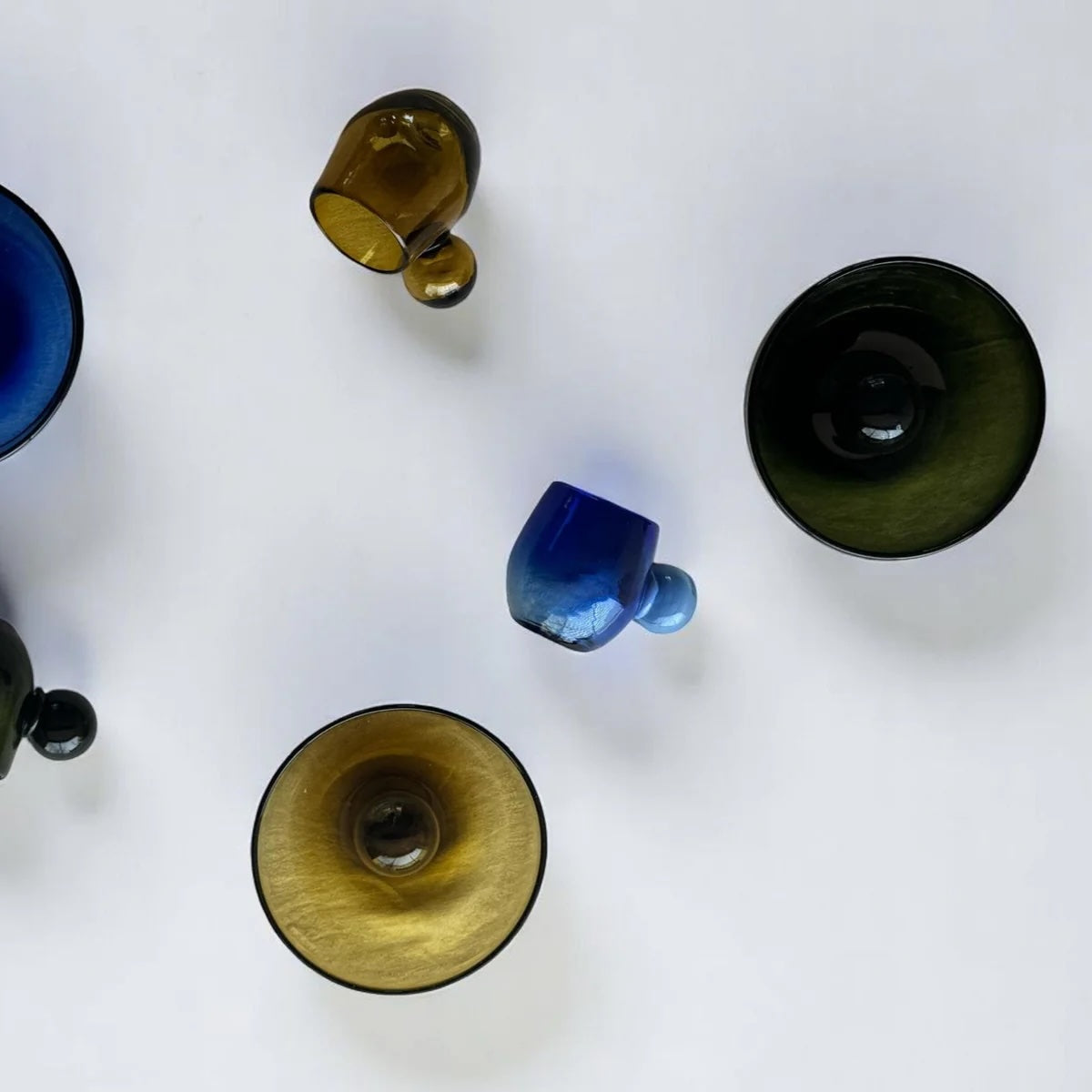 Top-down view of various glasses on a white background