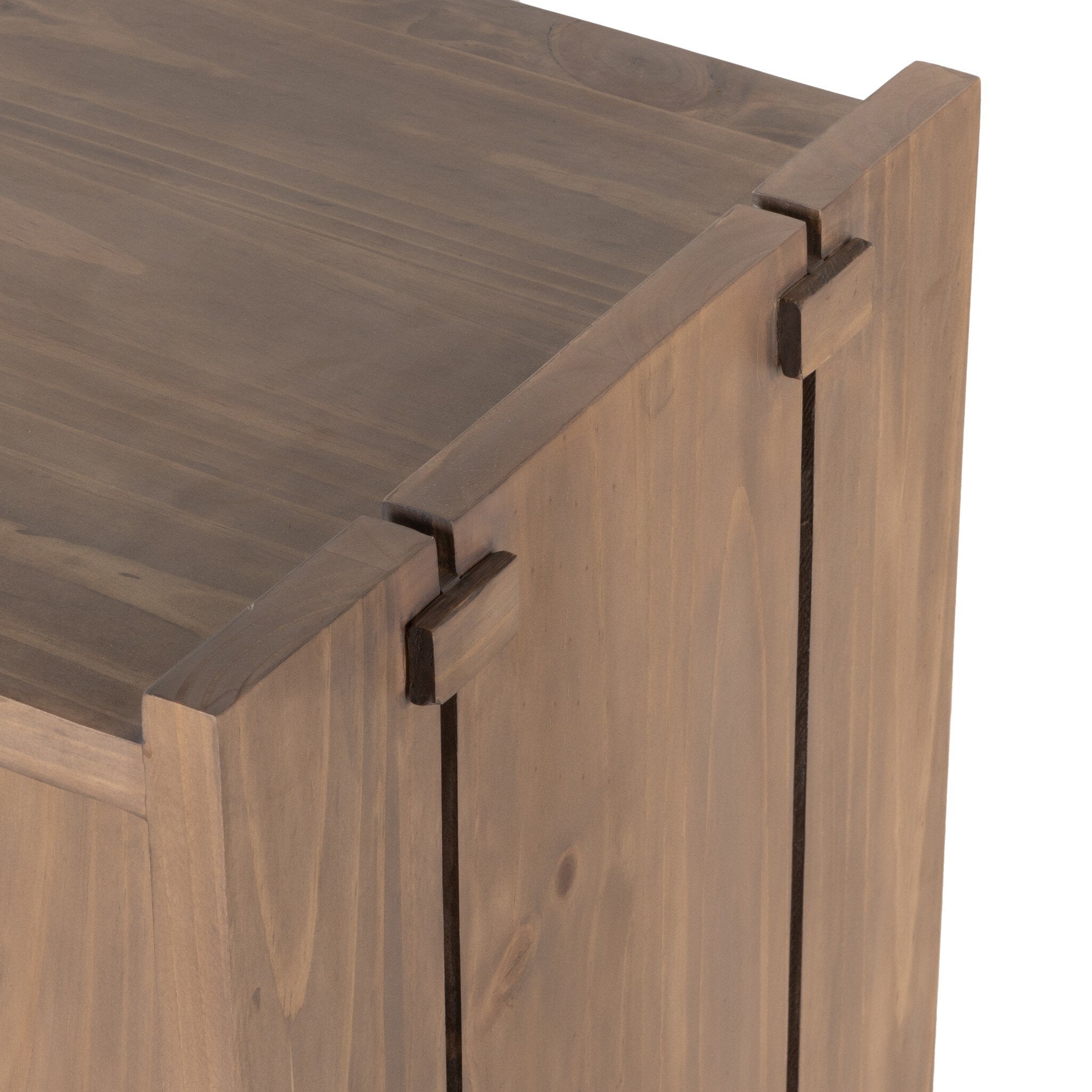 Close-up of a wooden cabinet with a visible hinge on a white background