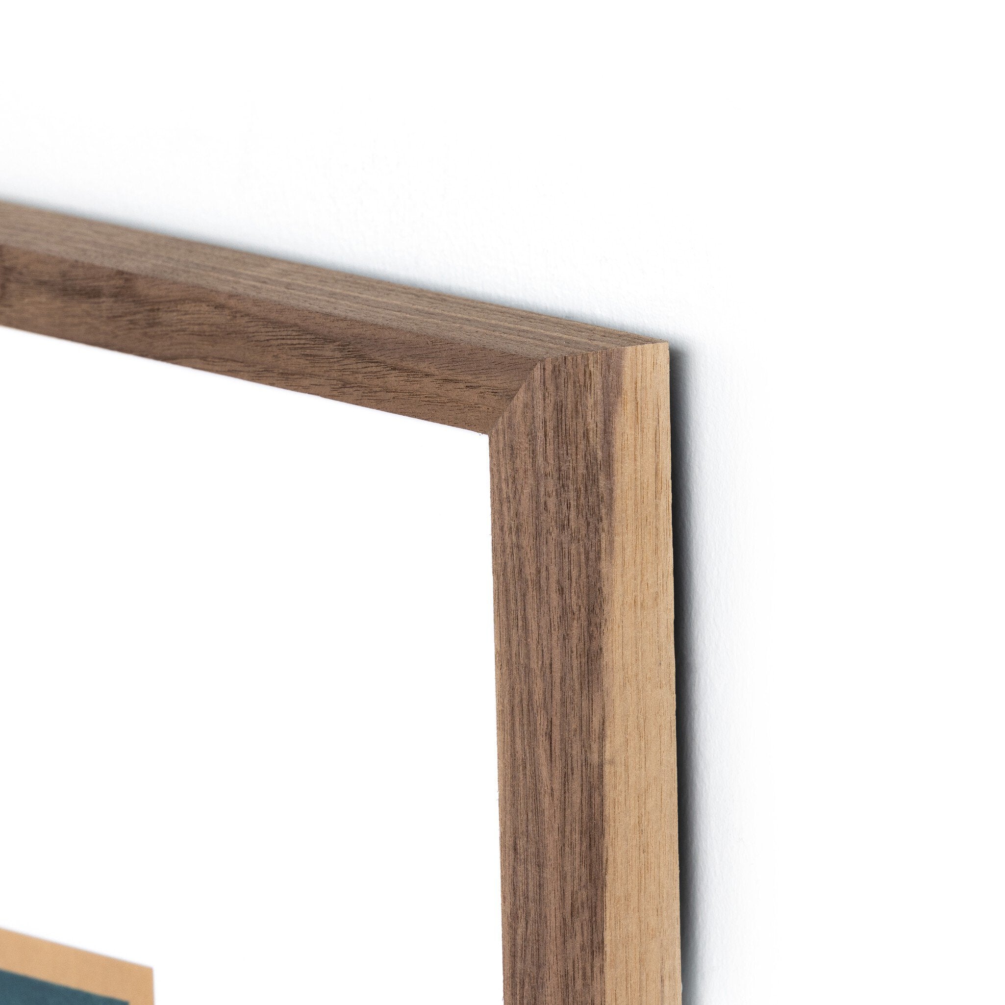Close-up of a wooden picture frame corner on a white background