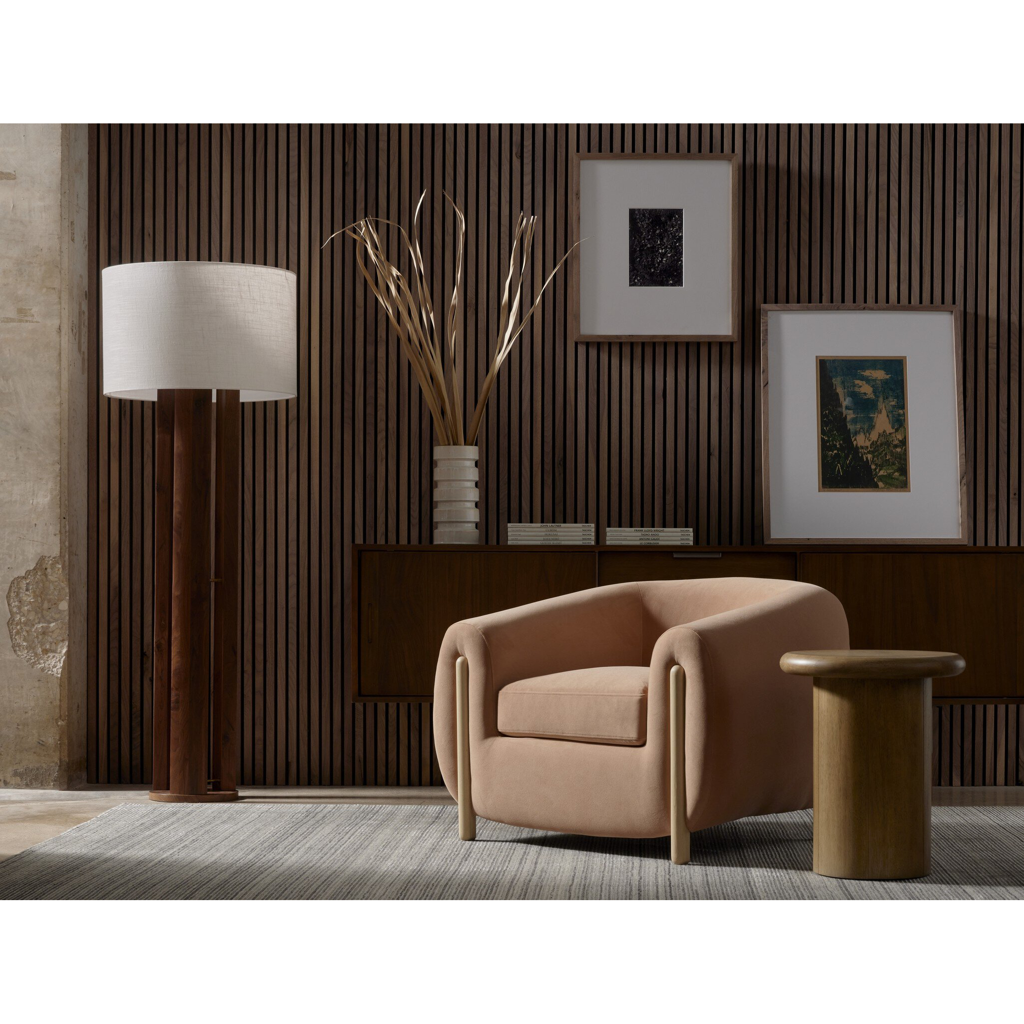 Modern living room with a beige armchair, floor lamp, and wall art.