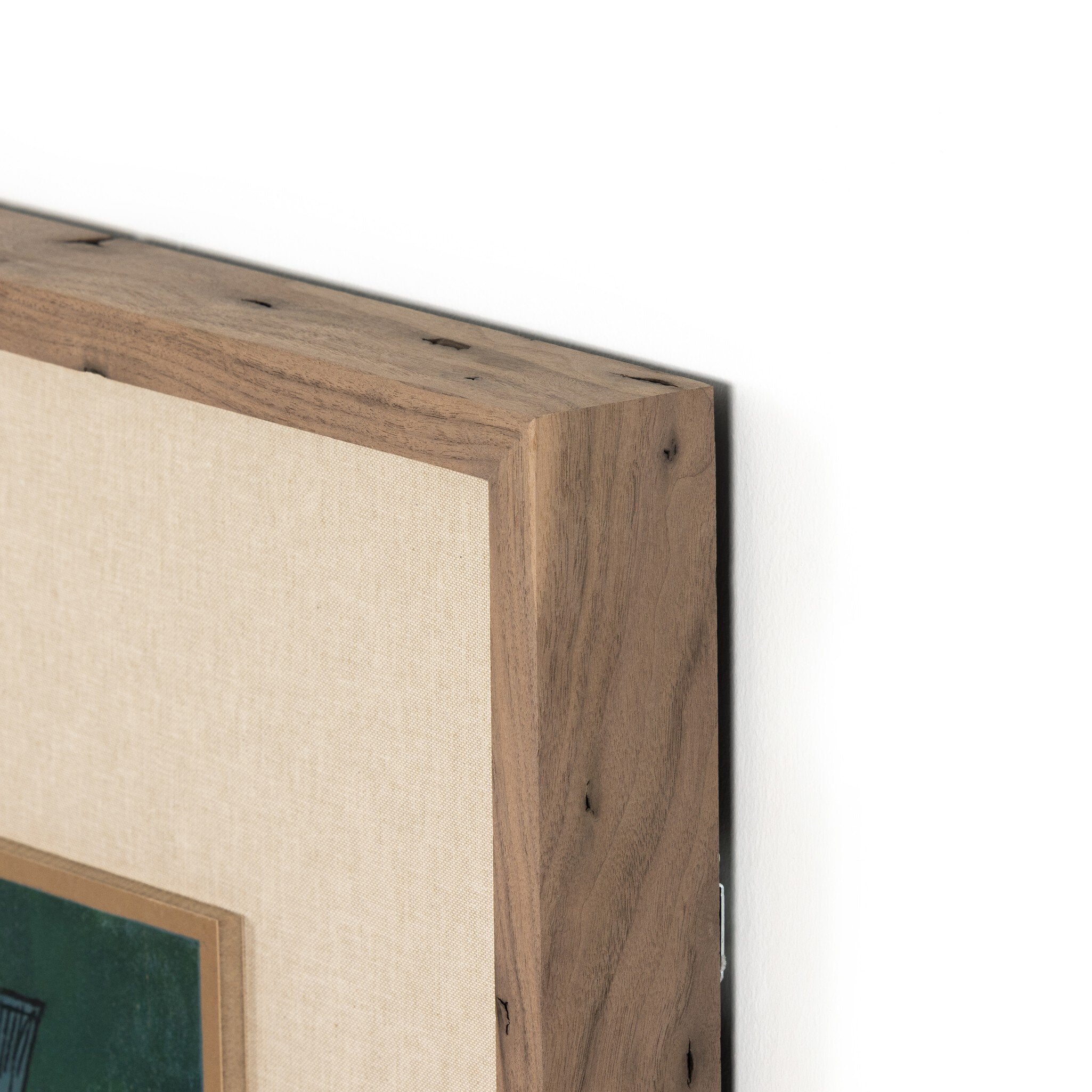 Close-up of a wooden picture frame corner with a white background