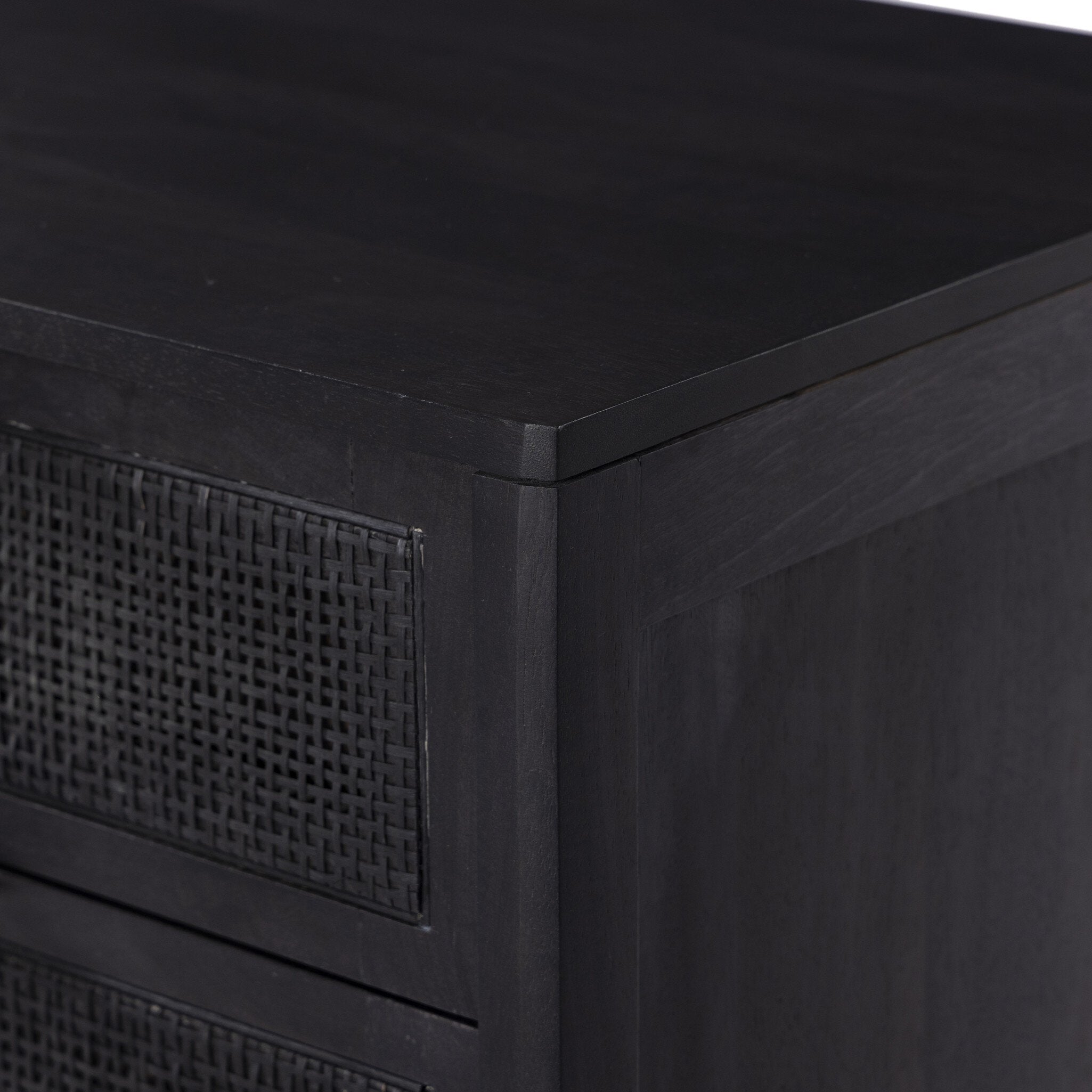 Black cabinet with textured panel on a white background