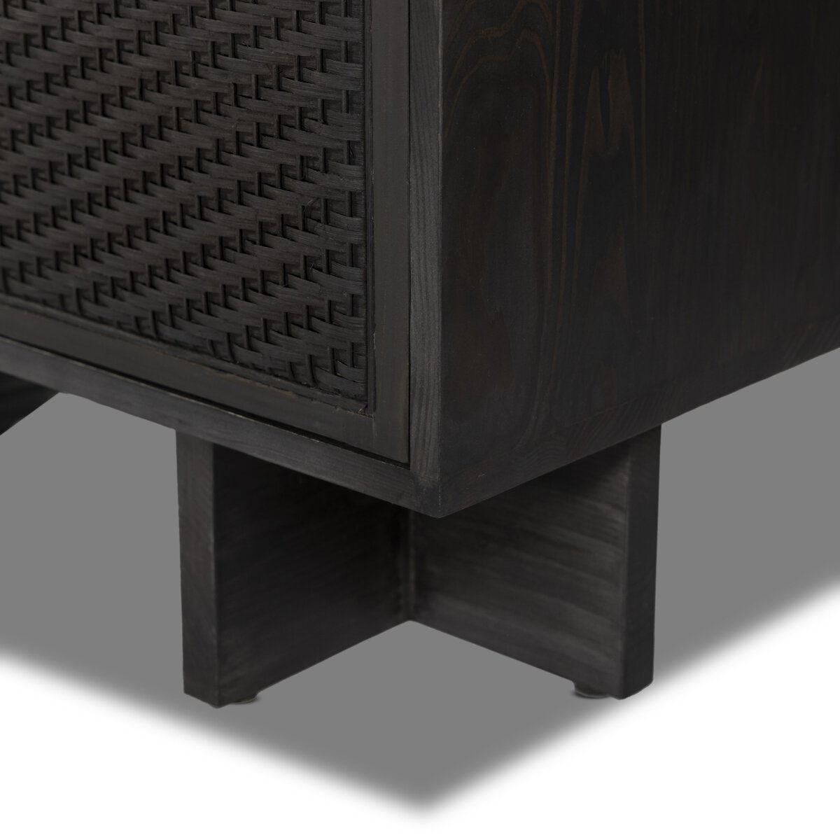 Dark wooden cabinet with woven pattern on a gray background