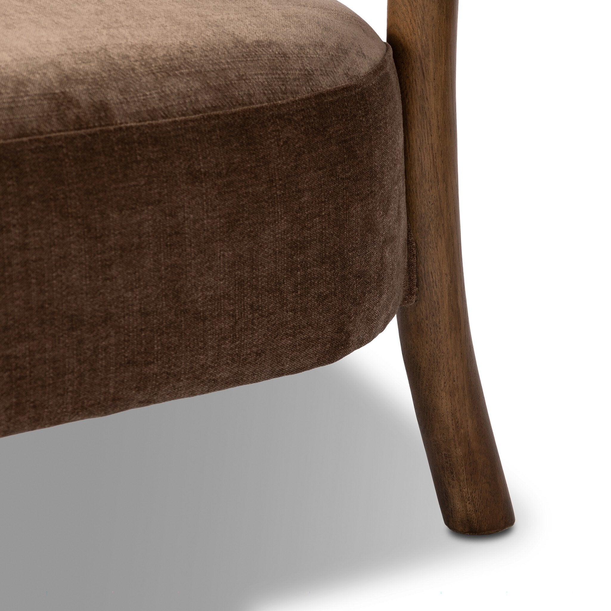 Brown upholstered chair with wooden leg on a white background