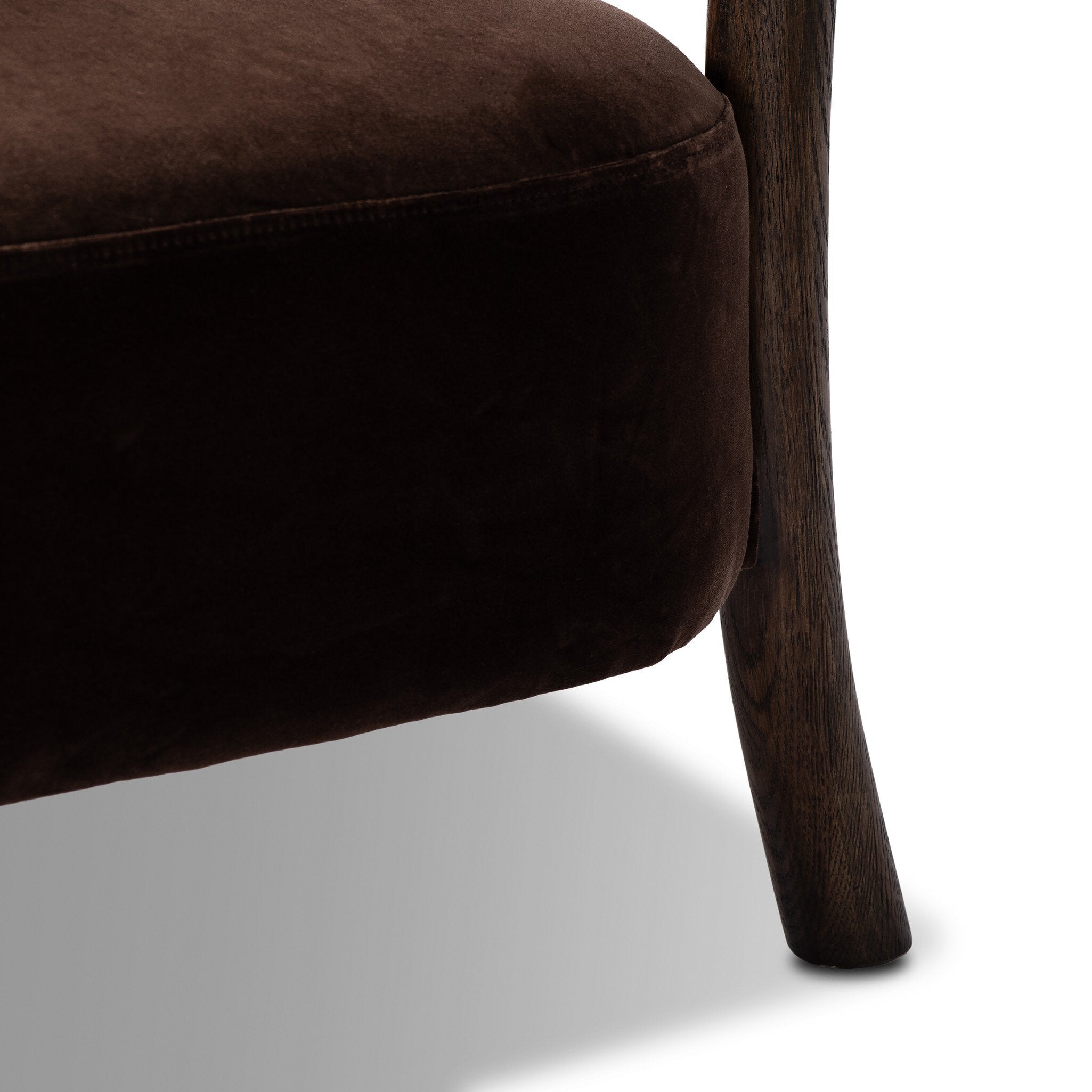 Brown upholstered chair with wooden legs on a white background
