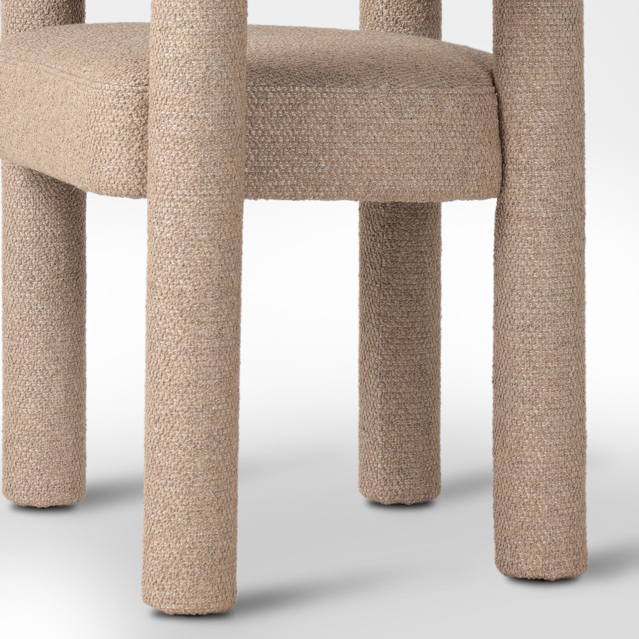 Close-up of a textured chair with beige cushioned seat on a white background