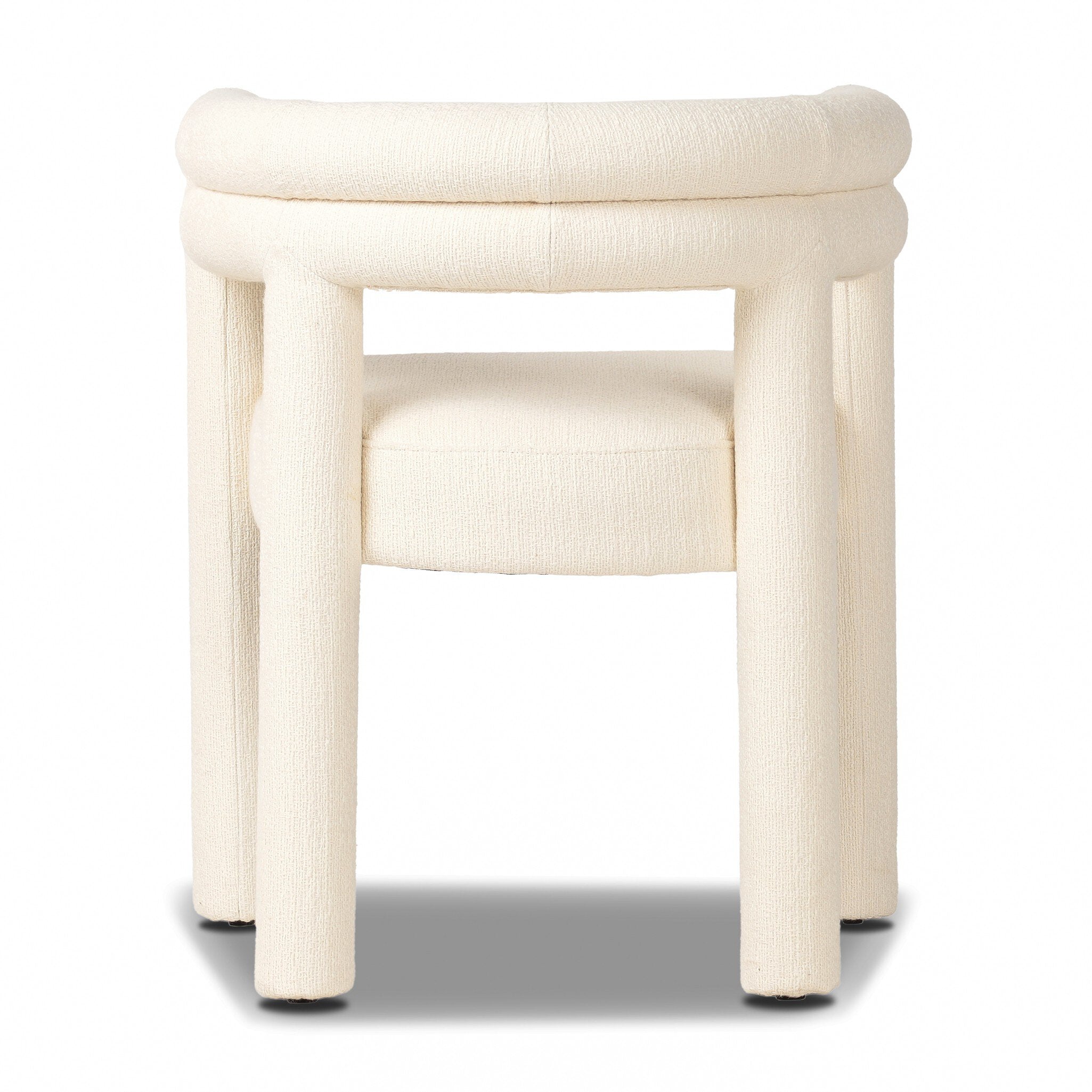 White textured upholstered dining chair on a white background