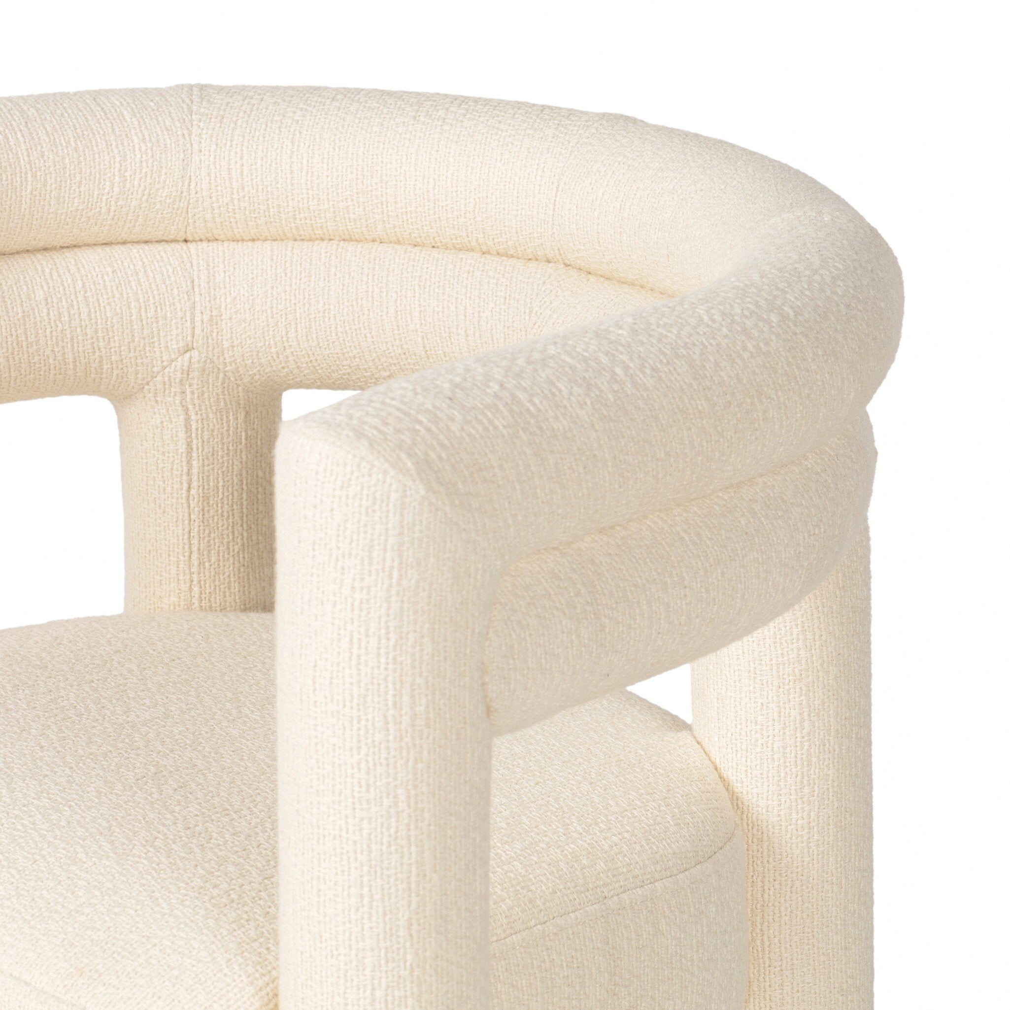Close-up of a cream-colored chair with a textured surface on a white background