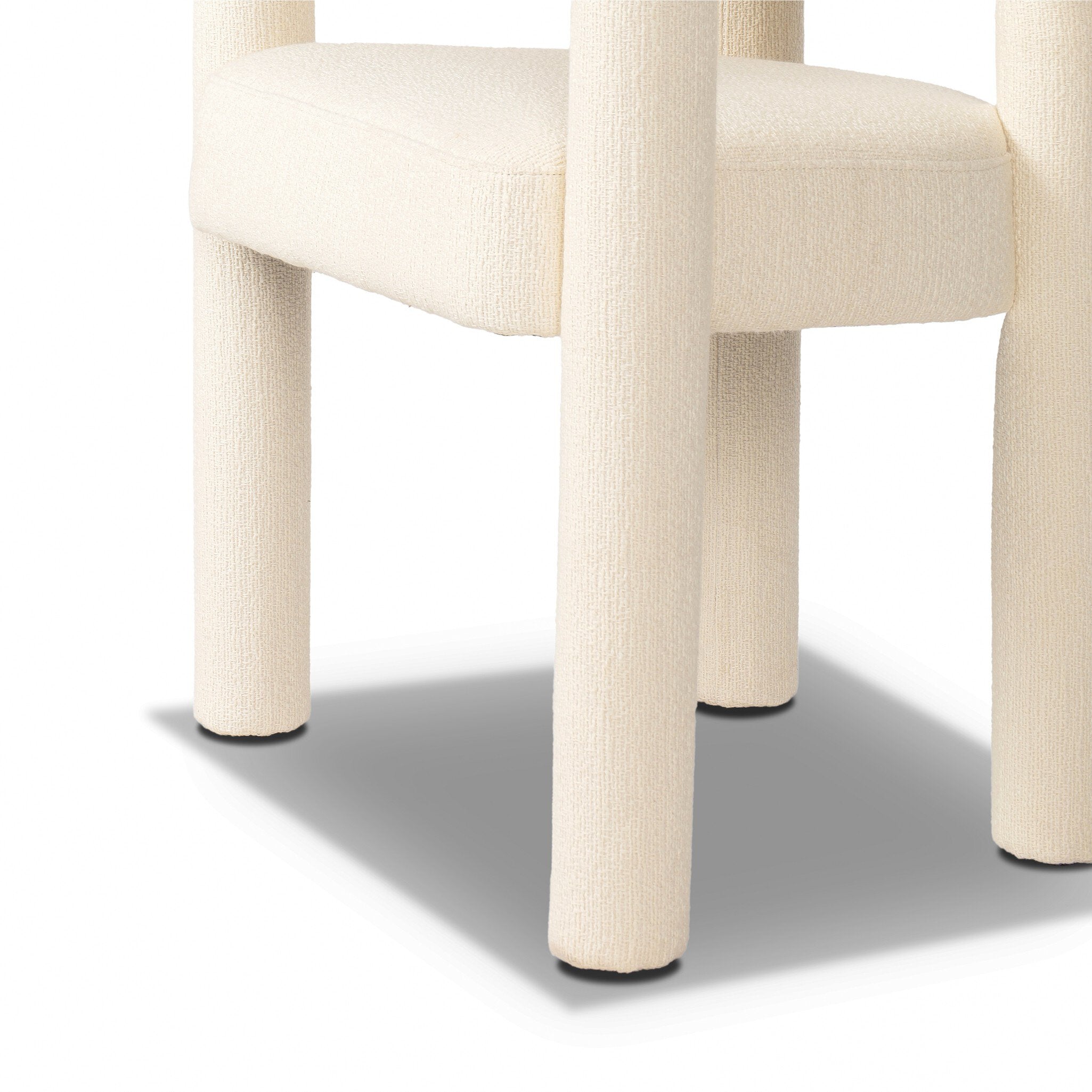 Close-up of a chair with beige cushioned seat and legs on a white background