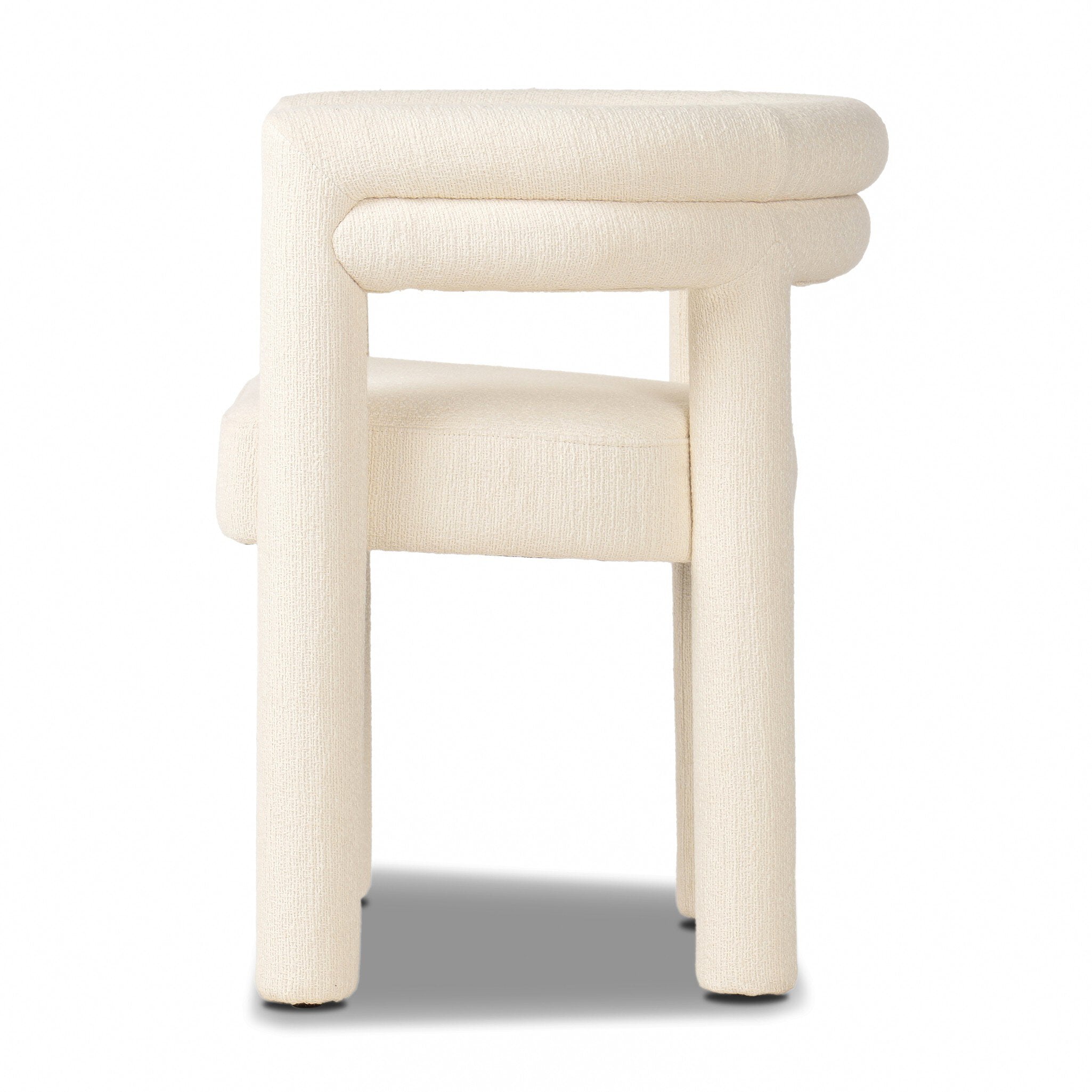 Cream colored dining chair on a white background