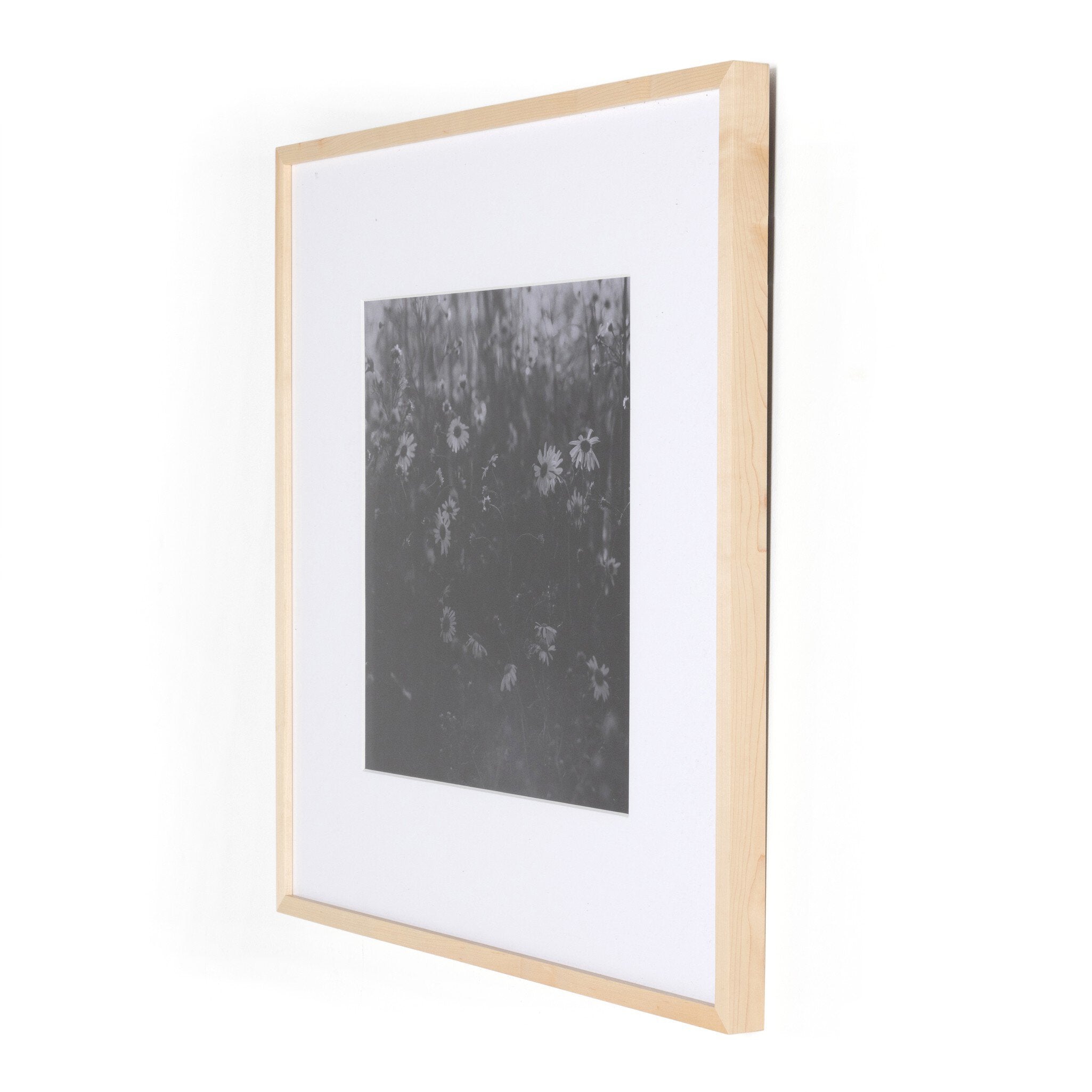 Framed artwork with a black and white abstract design on a white background