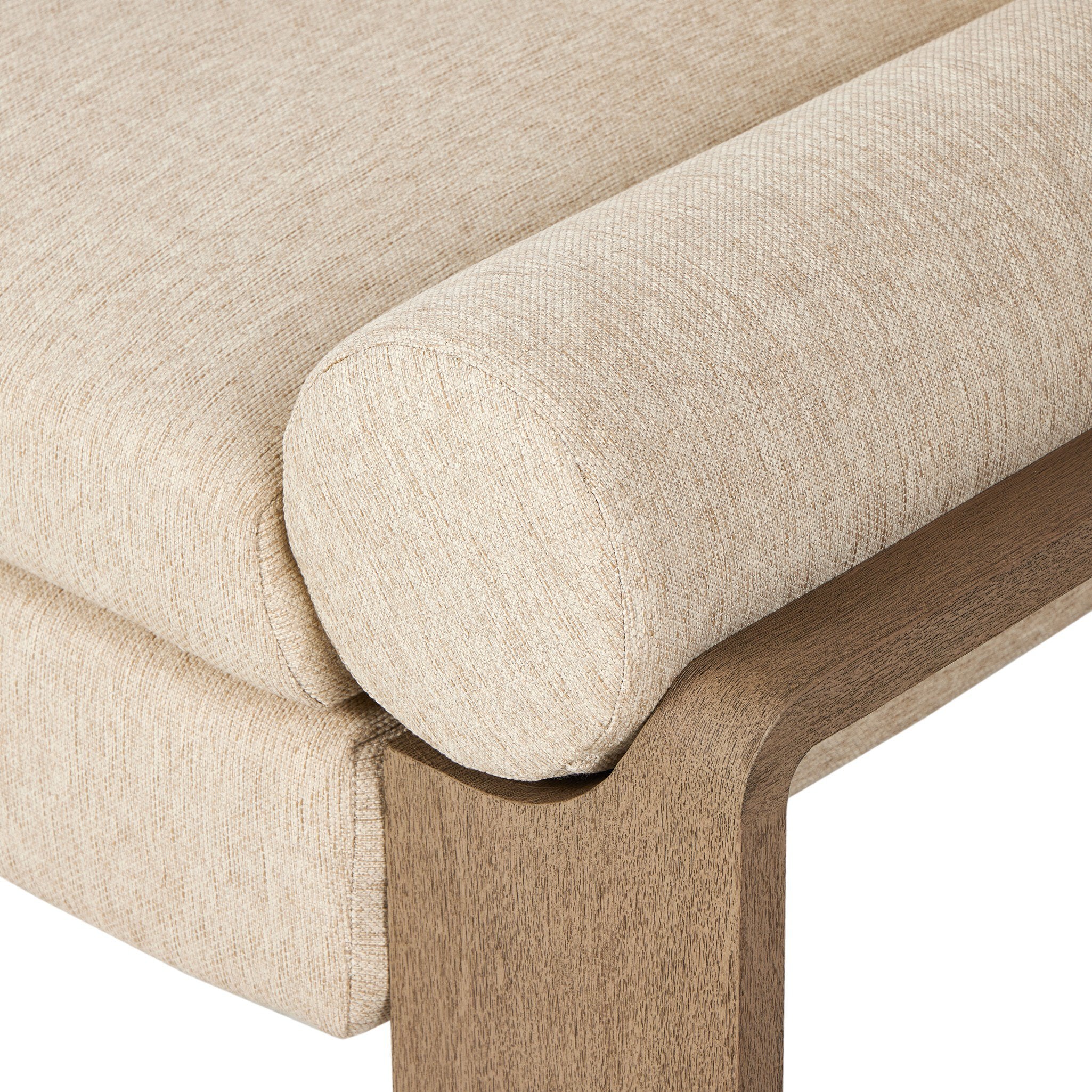 Close-up of a beige upholstered sofa with wooden legs on a white background