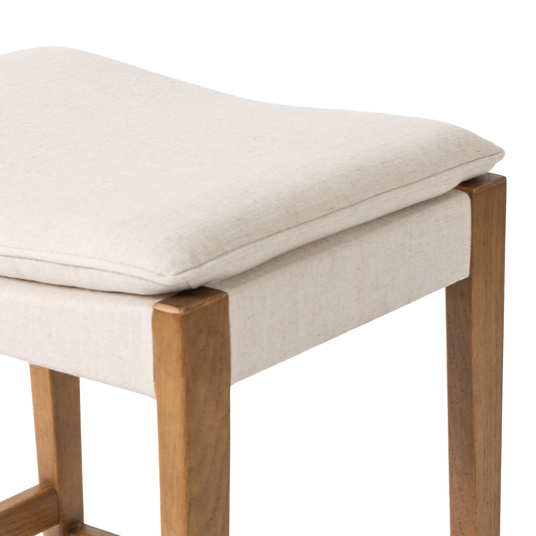 Wooden bar stool with a beige cushioned seat on a white background