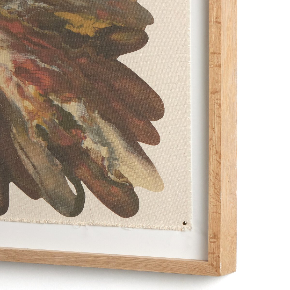 Framed artwork of a leaf with a wooden frame on a white background