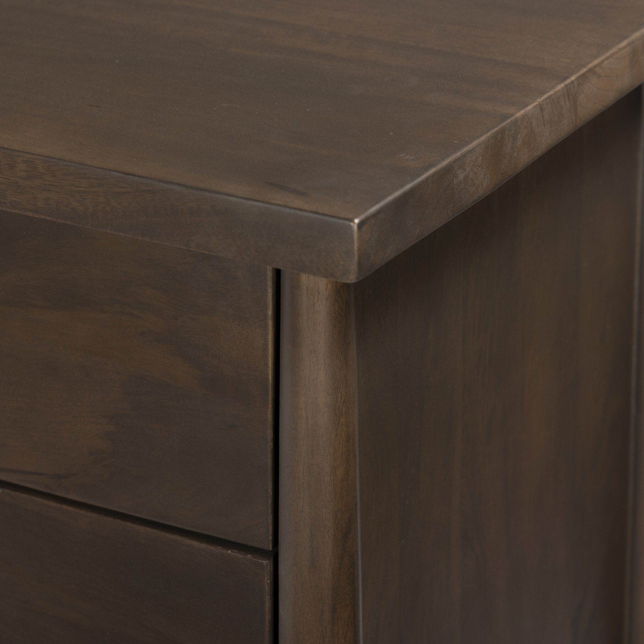 Close-up of a dark wooden dresser corner