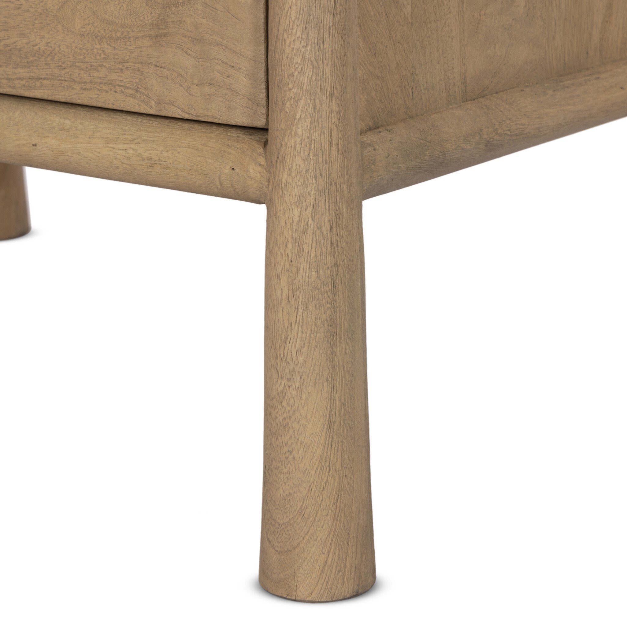 Close-up of a wooden drawer with a light finish on a white background