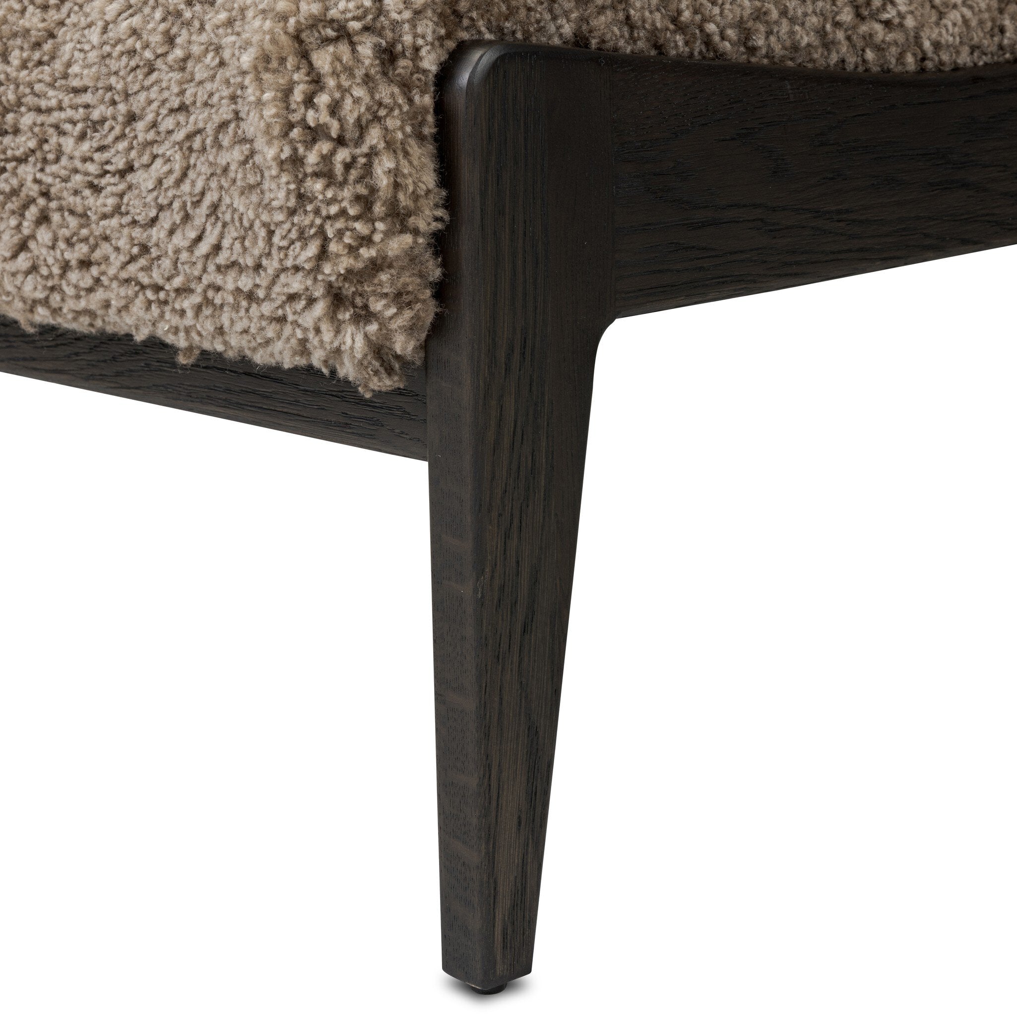 Close-up of a textured surface with a wooden frame on a white background