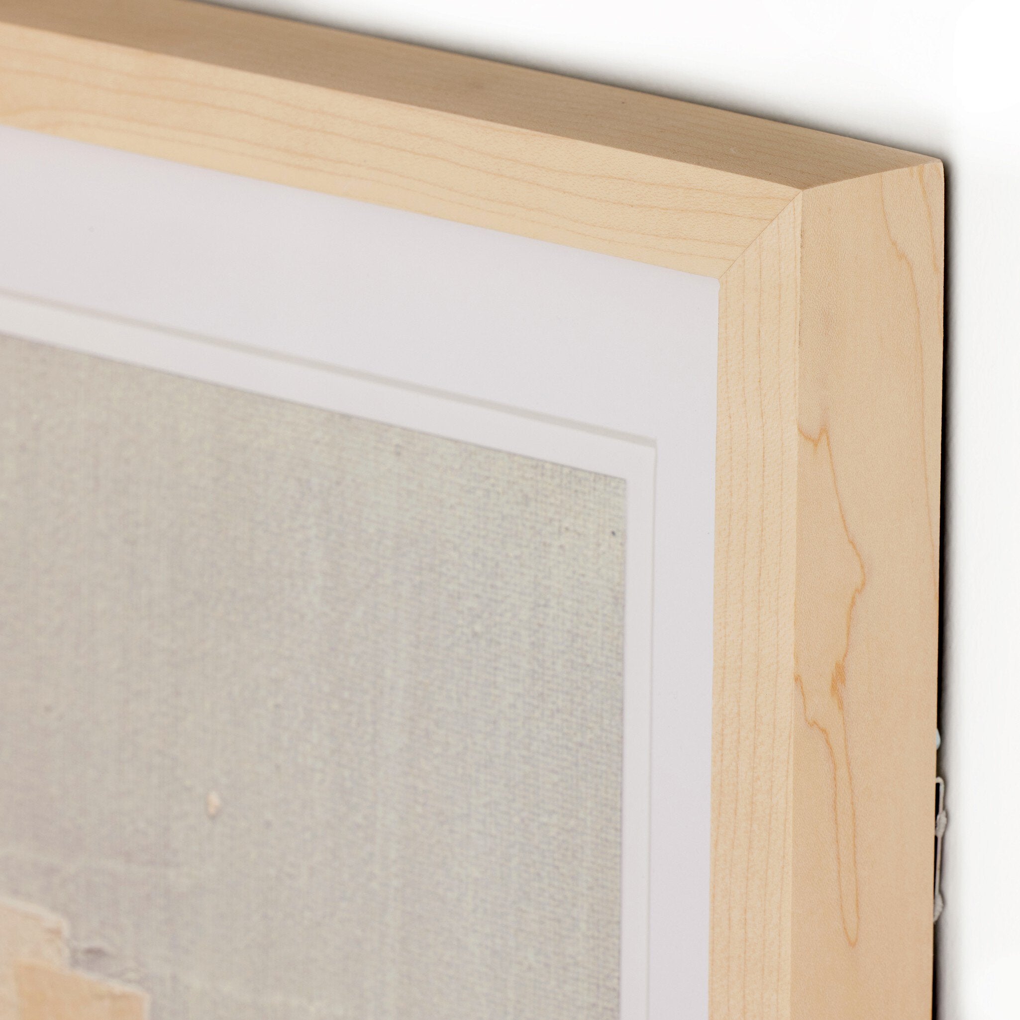 Close-up of a wooden picture frame with a textured wall background