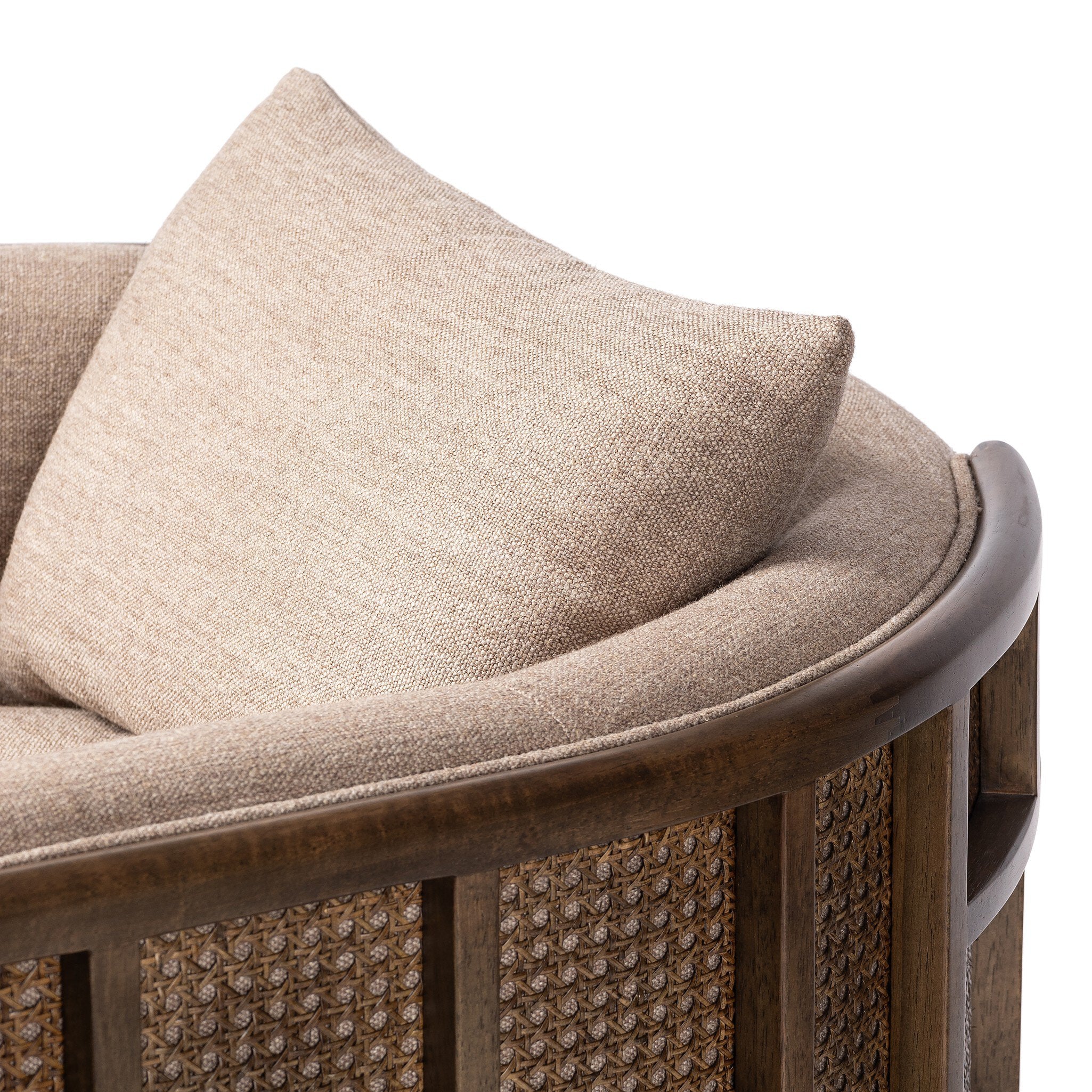 Beige cushion on a wicker chair with a white background