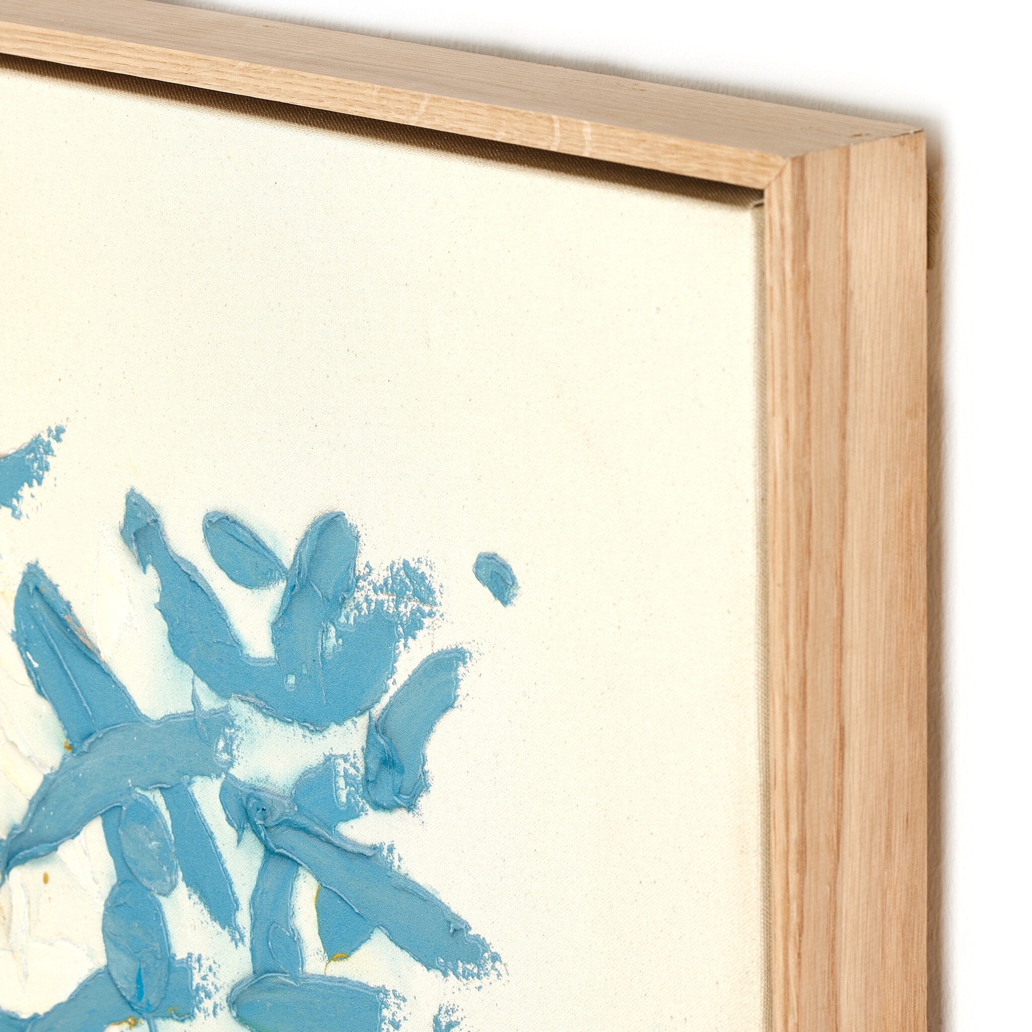 Abstract blue painting on a beige background with a wooden frame.